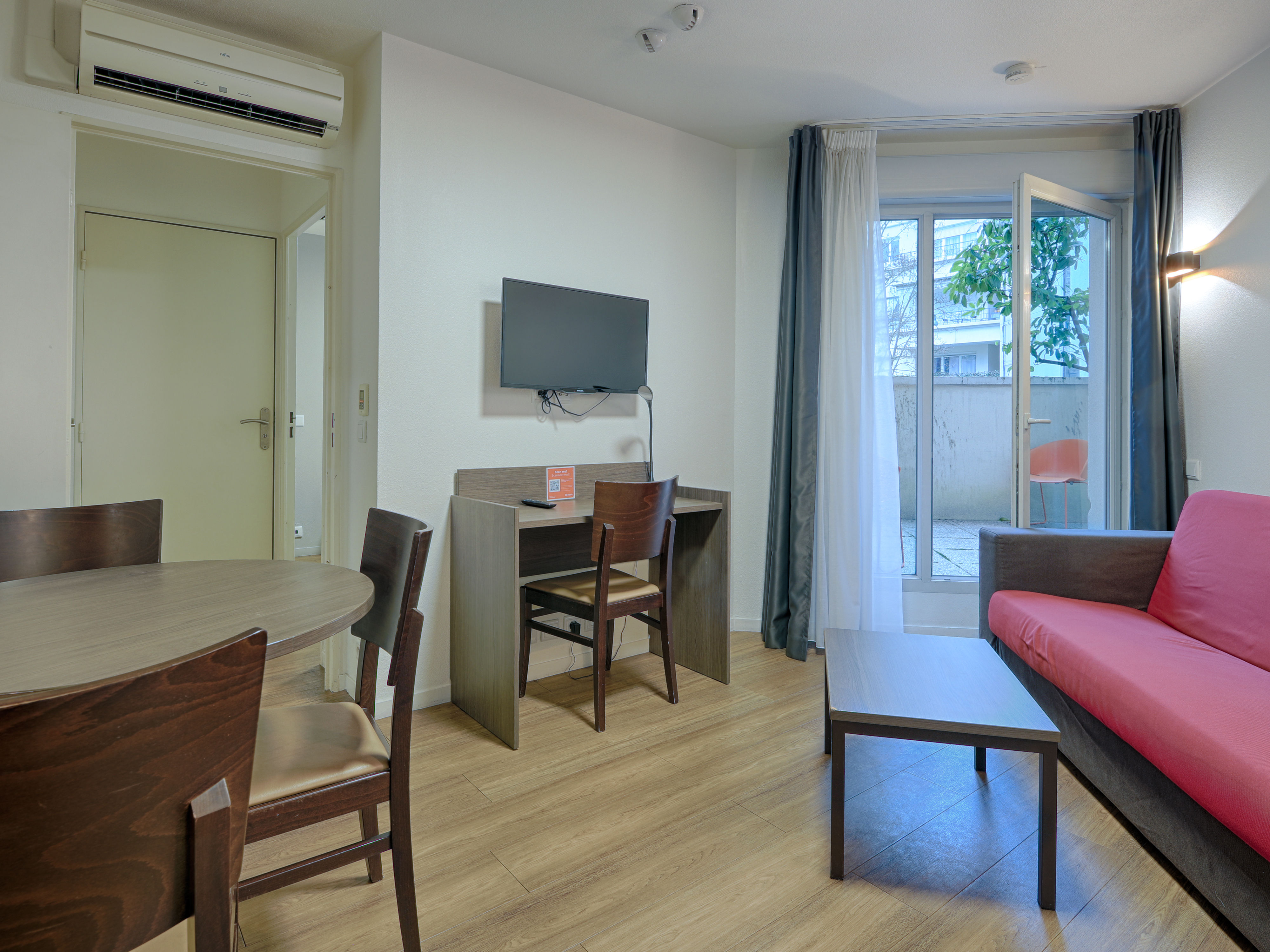 image Spacious living area featuring a sofa bed and flat-screen TV, offering a comfortable space to unwind.