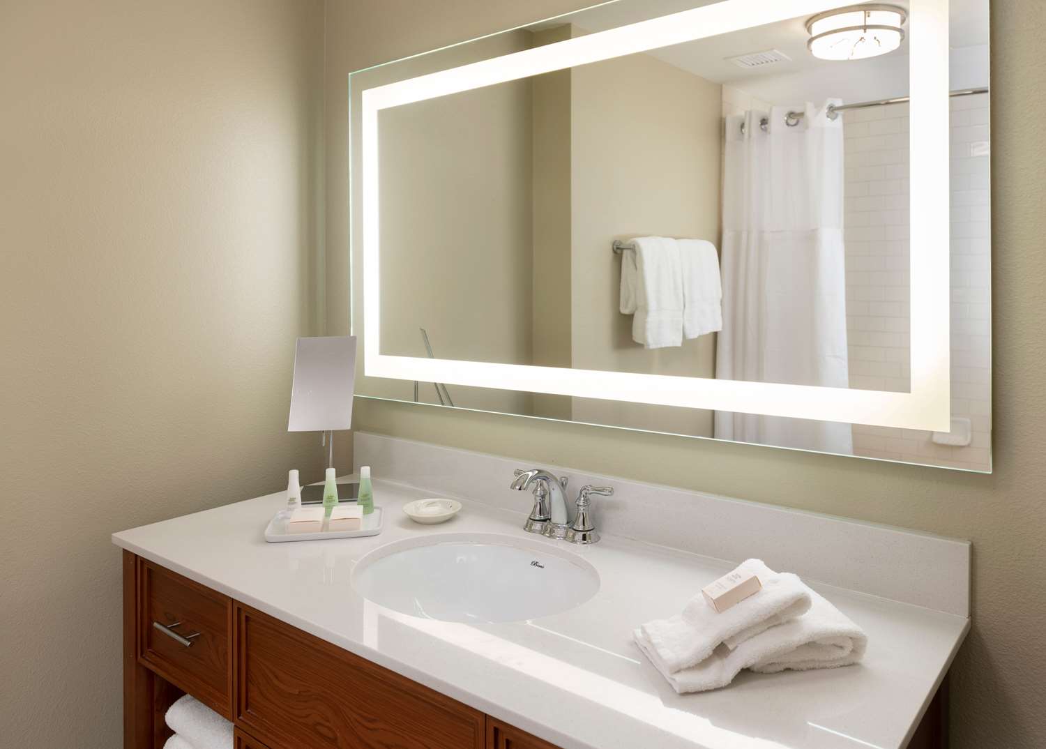 image Bright, modern vanity paired with soft lighting creates a refreshing space for winding down or starting the day.