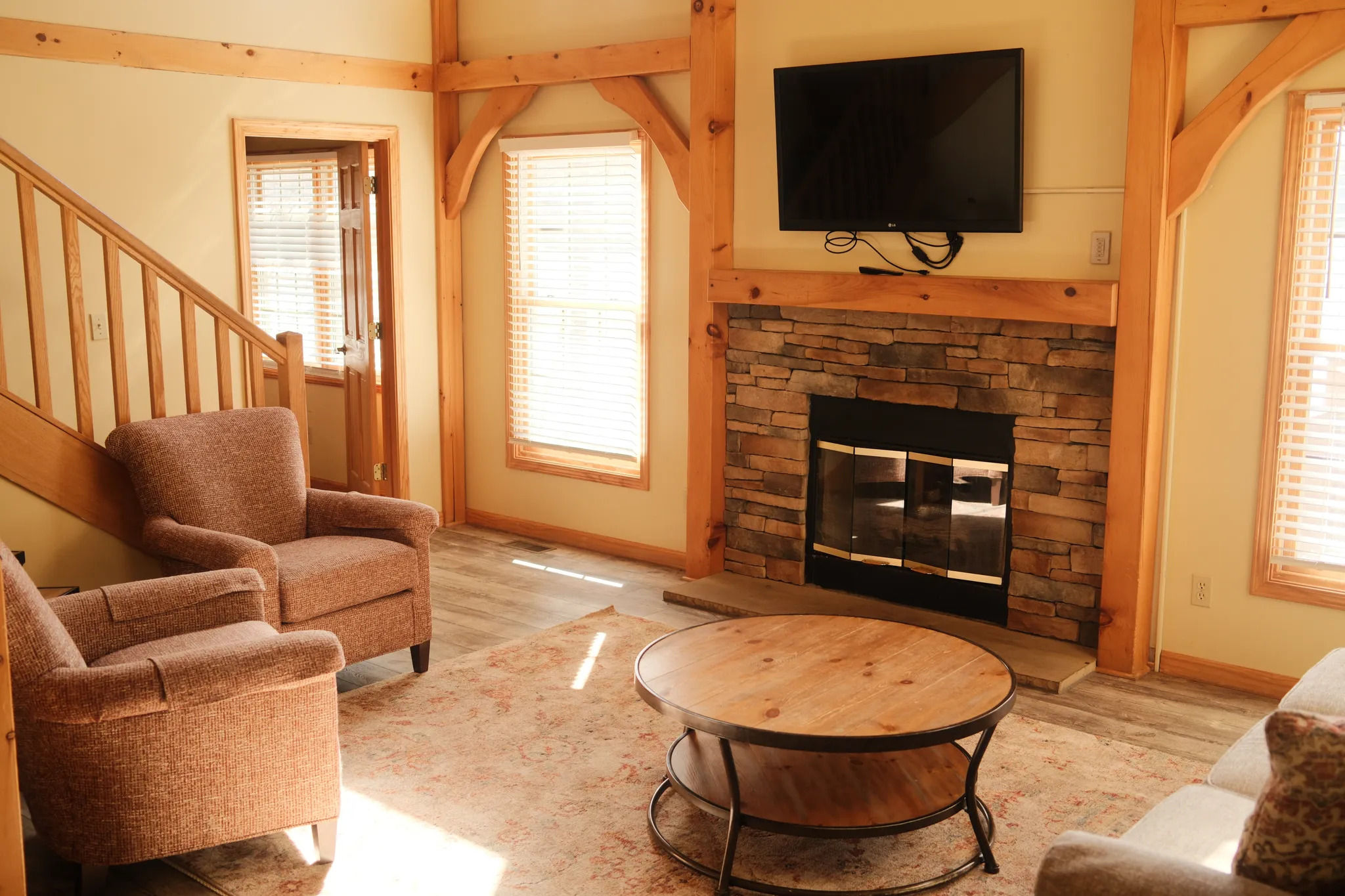 image Sun-filled living space with exposed beams and a gas fireplace brings mountain comfort to life.
