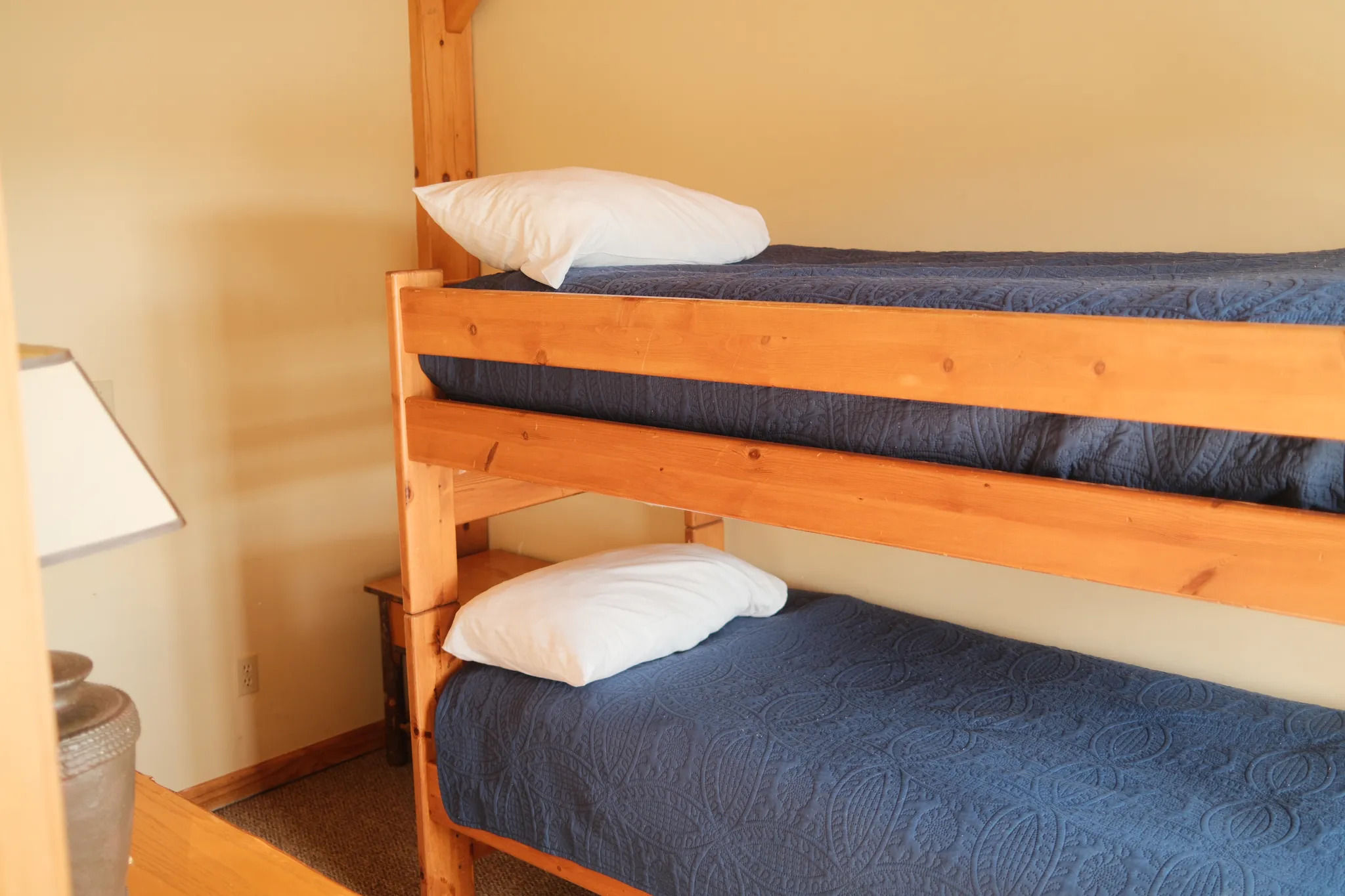 image Bunk beds and wood tones create a playful, lodge-inspired space for younger guests or cozy sleepovers.