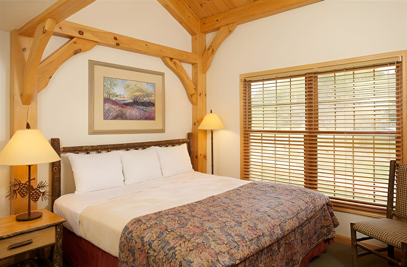 image Timber beams and soft lighting frame a restful bedroom that blends mountain charm with quiet comfort.