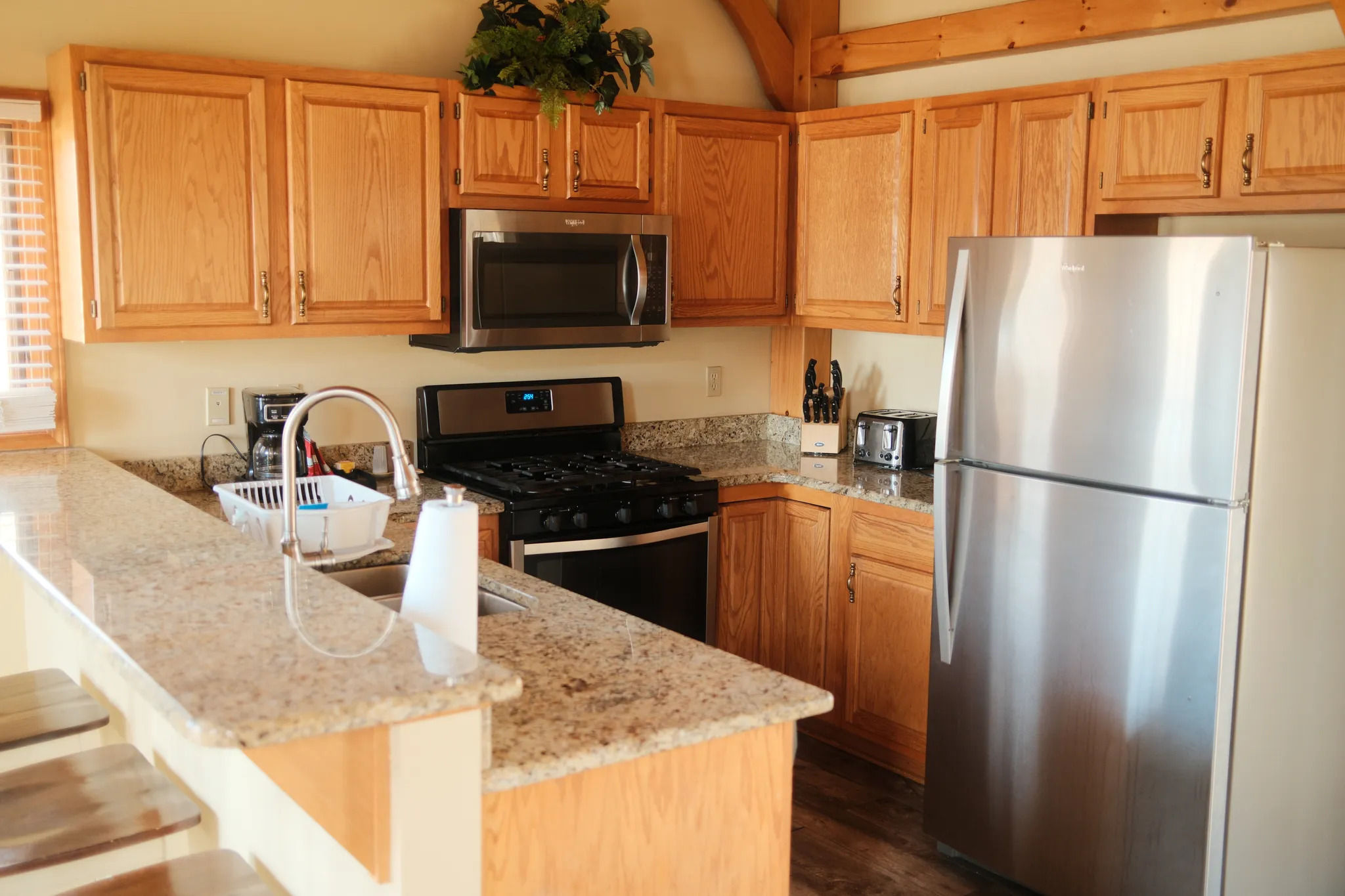 image Spacious kitchen with natural wood finishes invites relaxed cooking and shared meals in a rustic setting.
