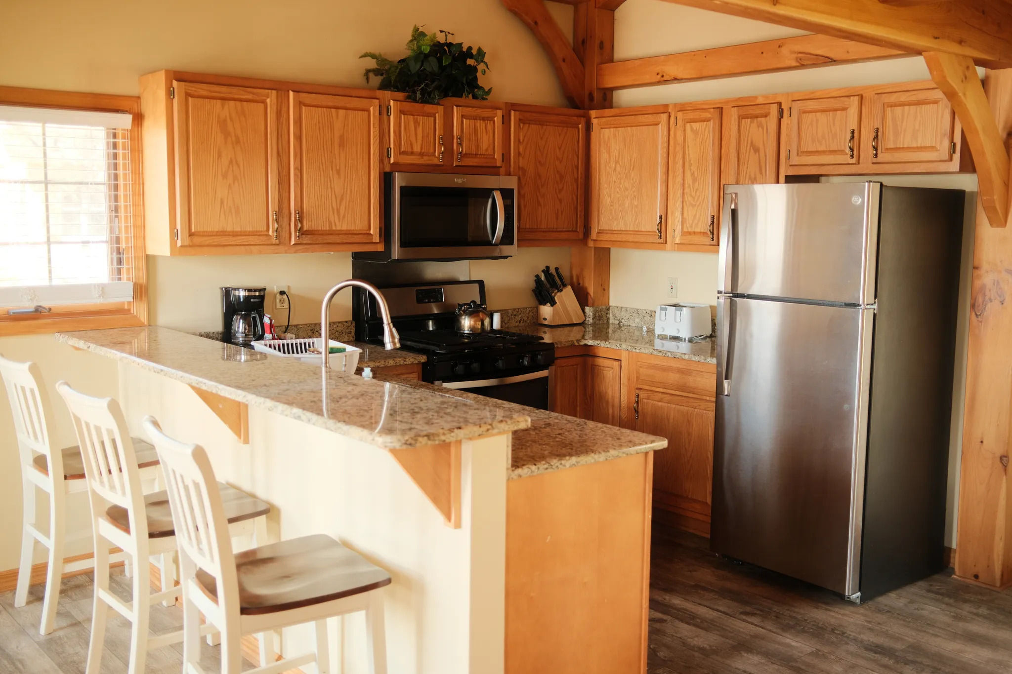 image Spacious kitchen with lodge-style finishes offers the perfect place to gather, cook, and unwind.