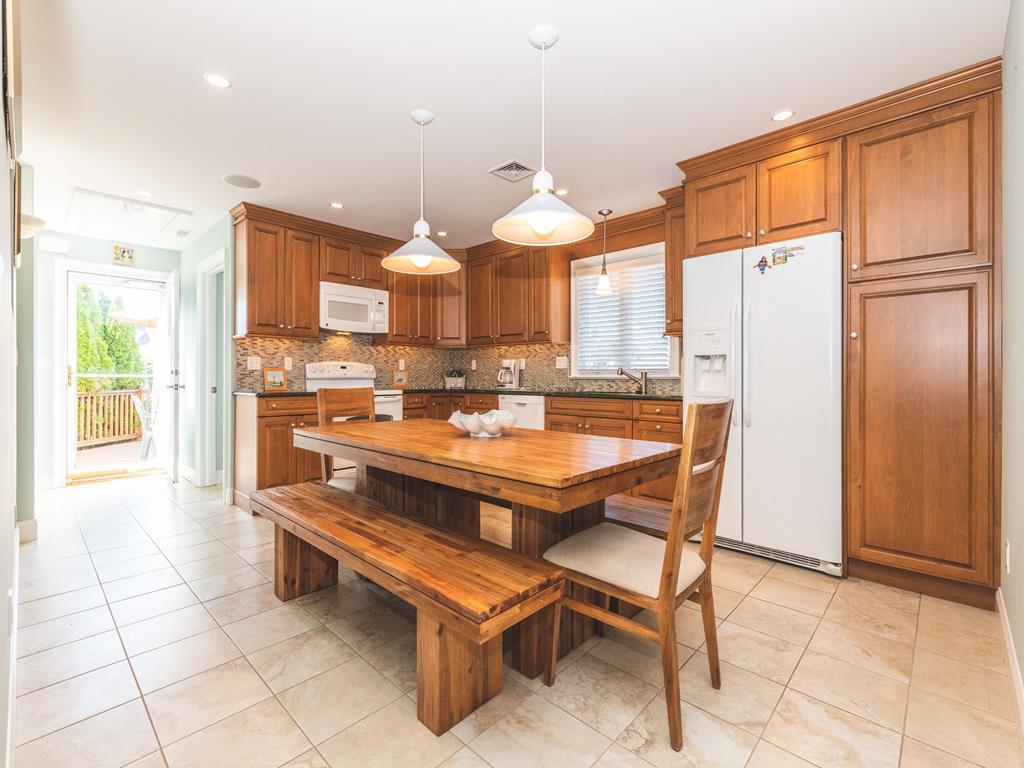 image Spacious kitchen with a wooden table seating eight.