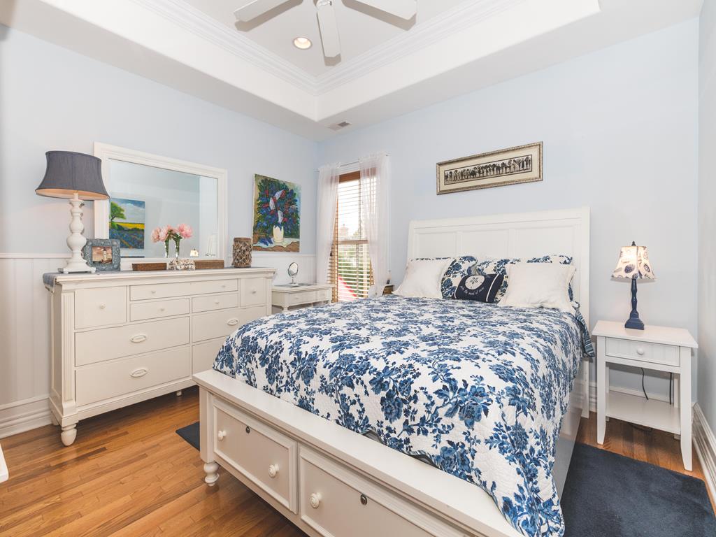 image Spacious primary bedroom with a classic design and soft lighting.