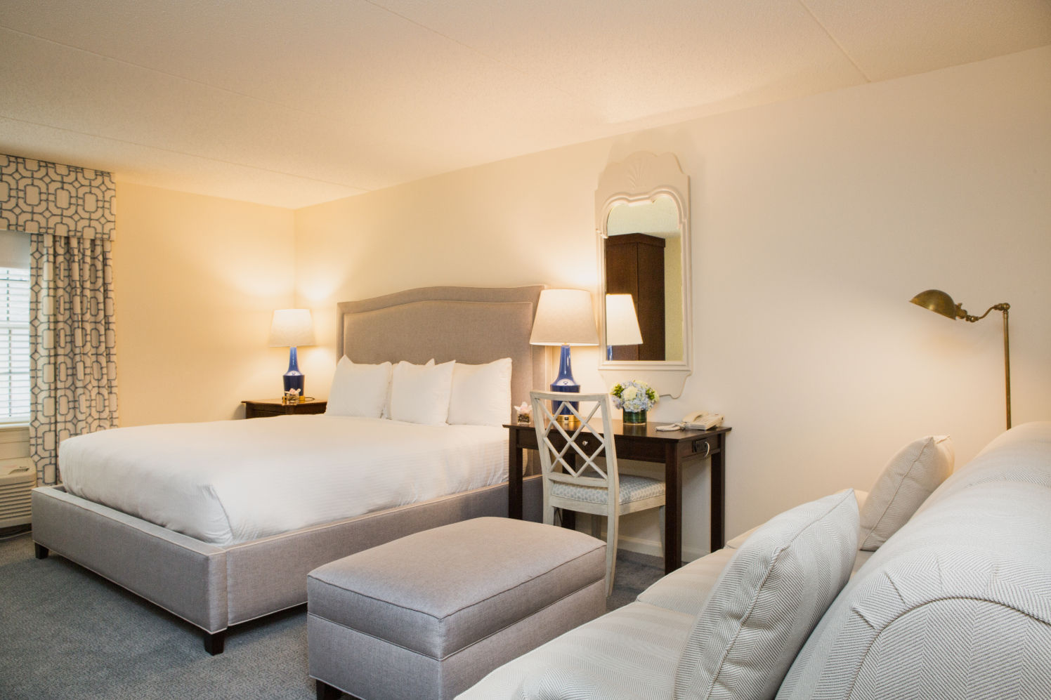 image A beautifully designed bedroom with plush seating and soft lighting for a cozy, restful retreat.