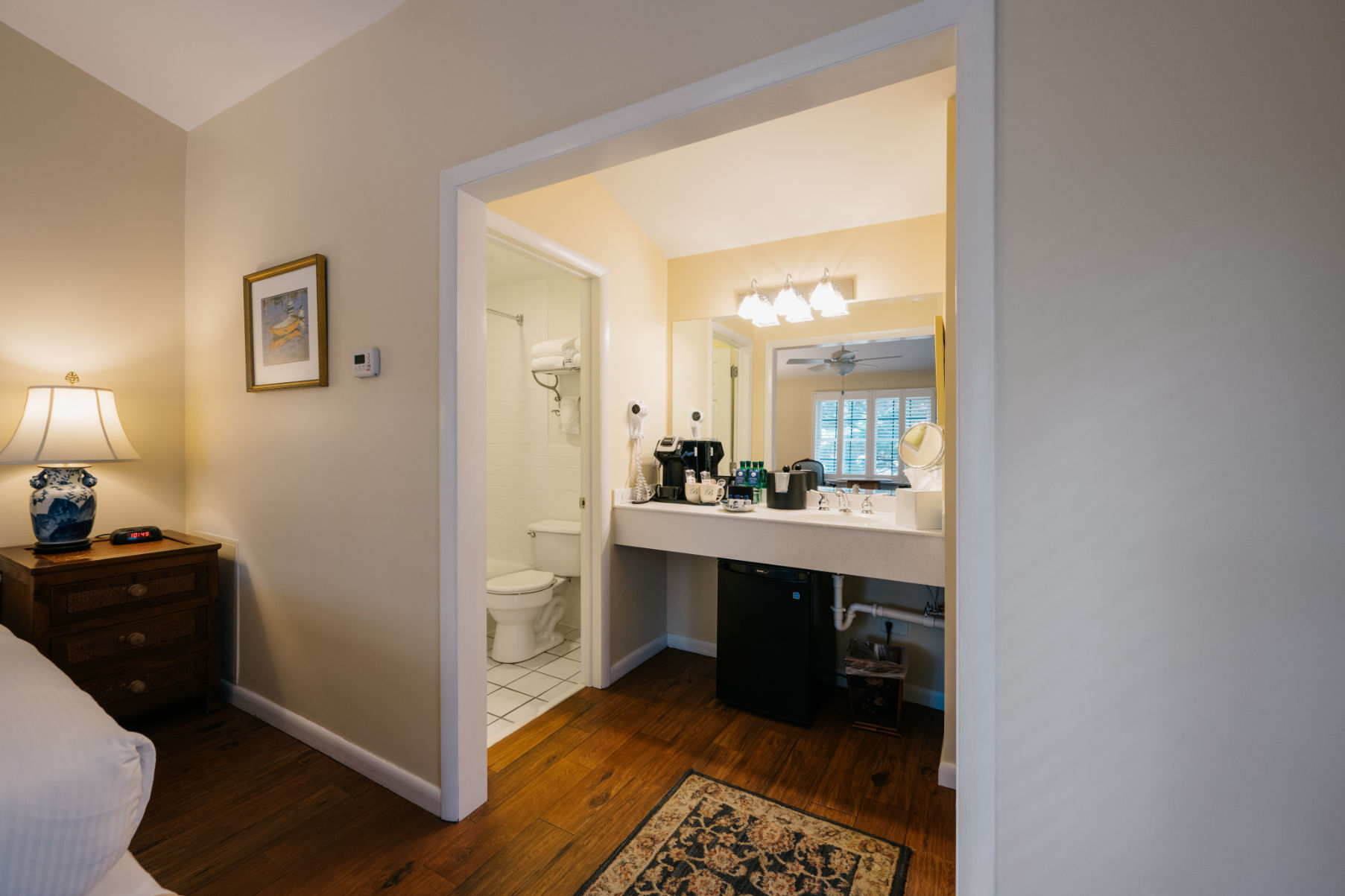 image A thoughtfully designed space with seamless access to a spacious and well-lit bathroom.