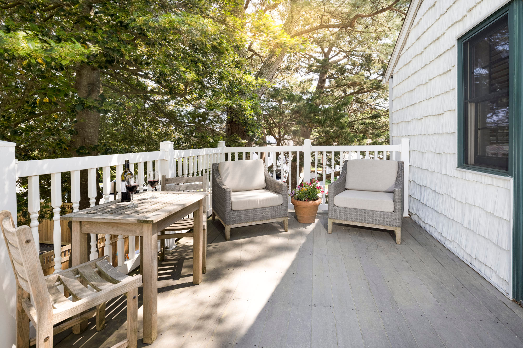 image A serene outdoor balcony with cozy seating, perfect for enjoying fresh air and nature.