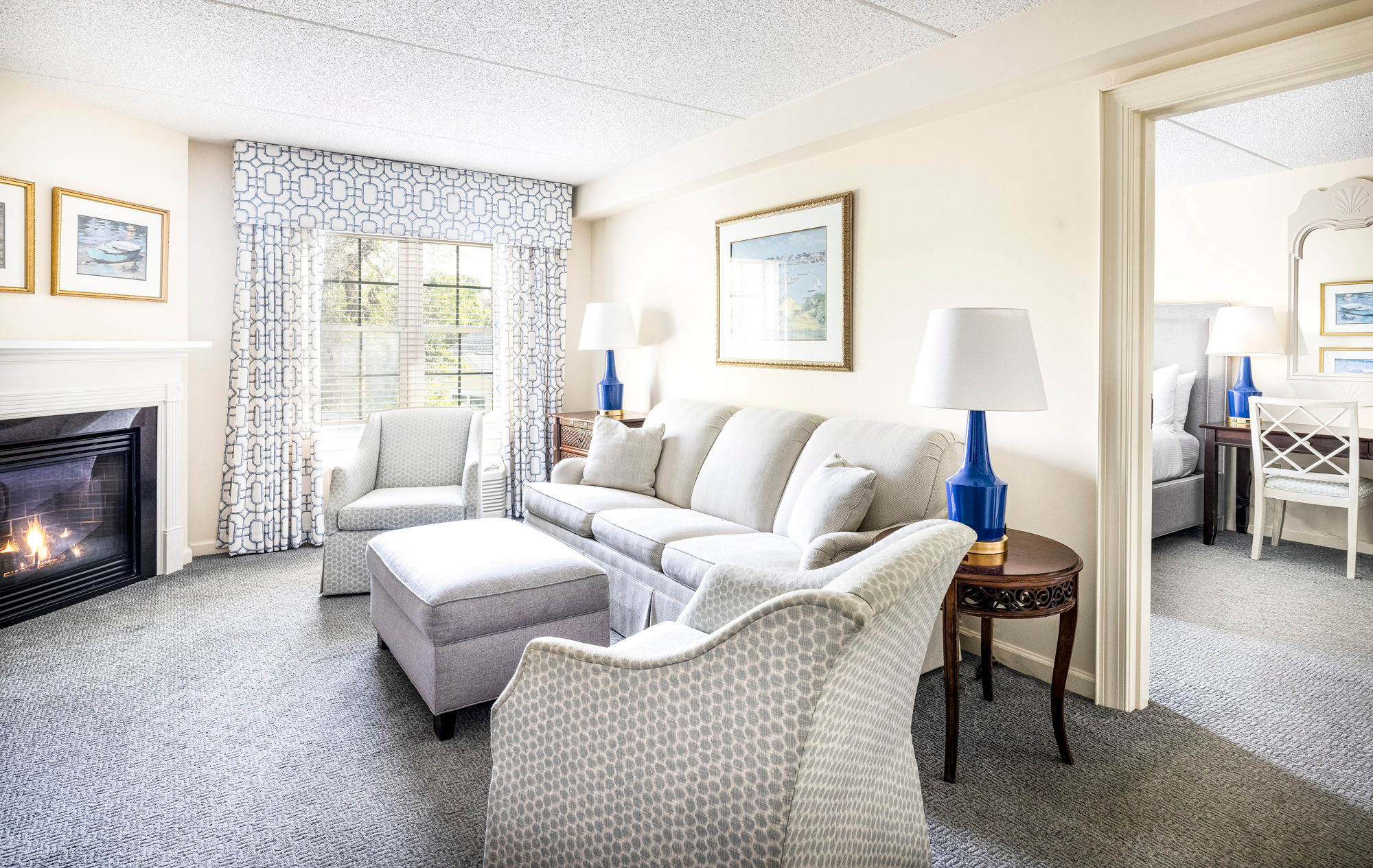 image Bright and inviting living space with plush seating, a cozy fireplace, and elegant decor for a relaxing retreat.