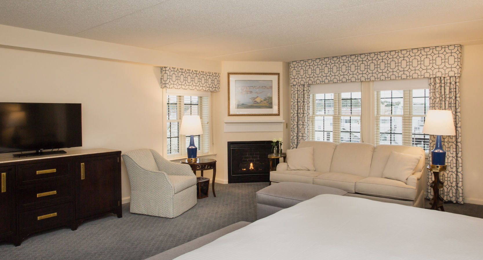 image Spacious and inviting suite with a cozy seating area, warm fireplace, and stylish decor for a relaxing stay.
