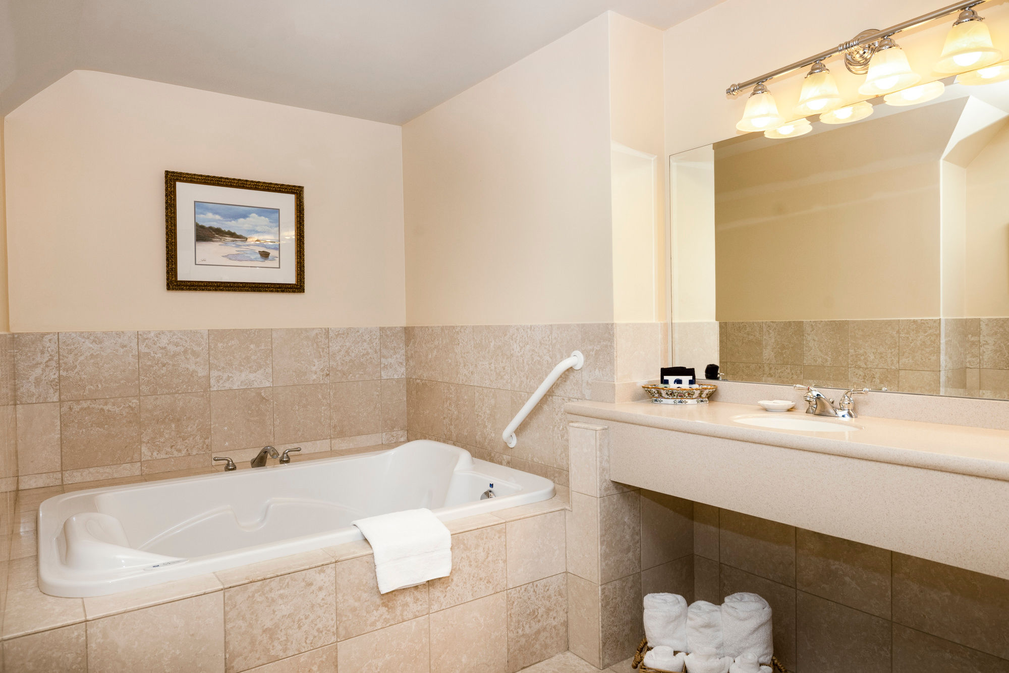 image Luxurious bathroom retreat featuring a deep soaking tub, elegant lighting, and a spacious vanity for a spa-like experience.