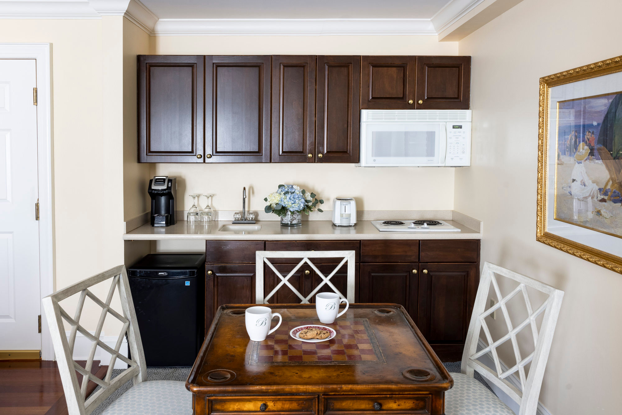 image A well-appointed kitchenette offers convenience and charm for a home-away-from-home experience.