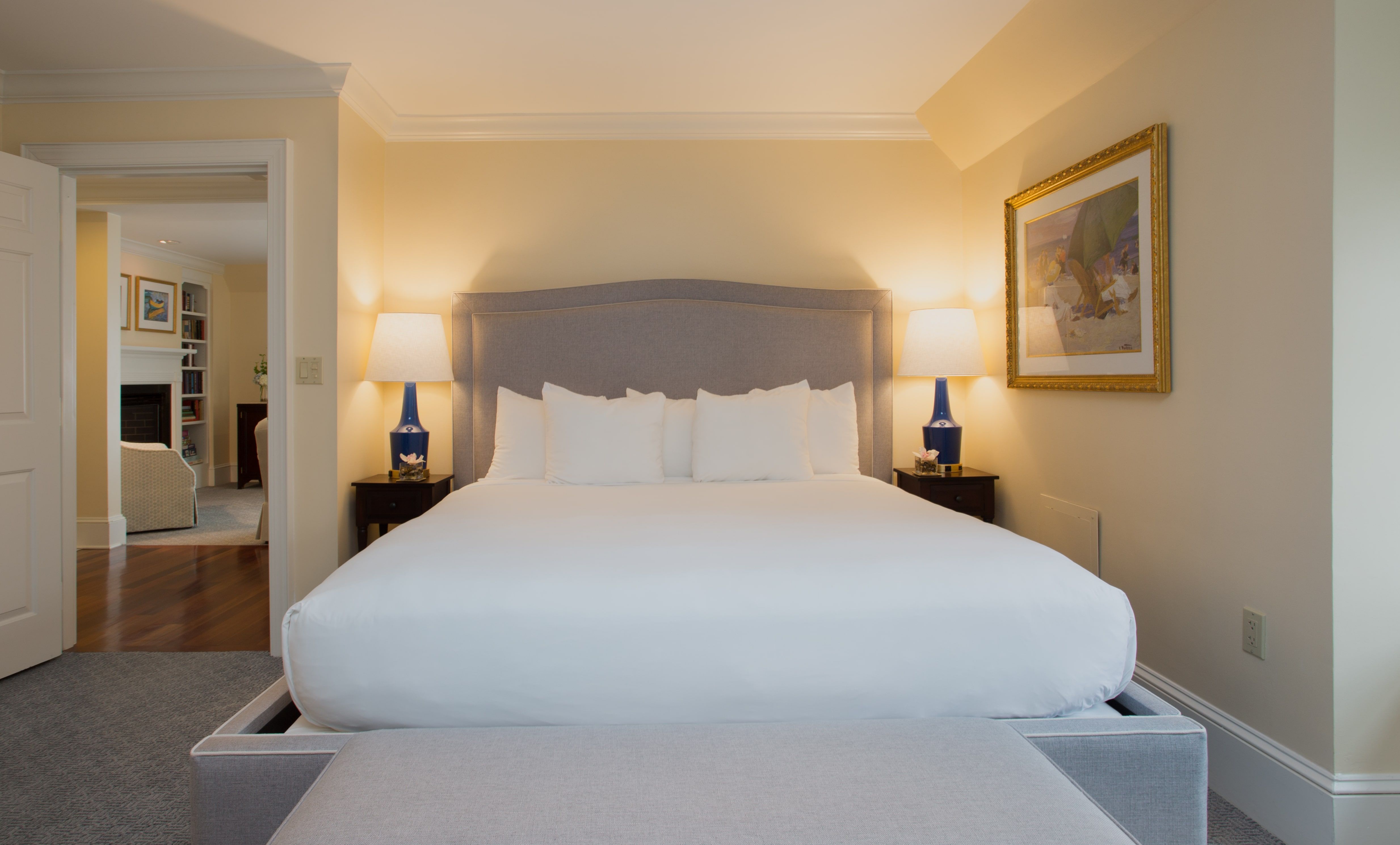 image Plush bedding and warm lighting invite you into a peaceful retreat for a restful night’s sleep.