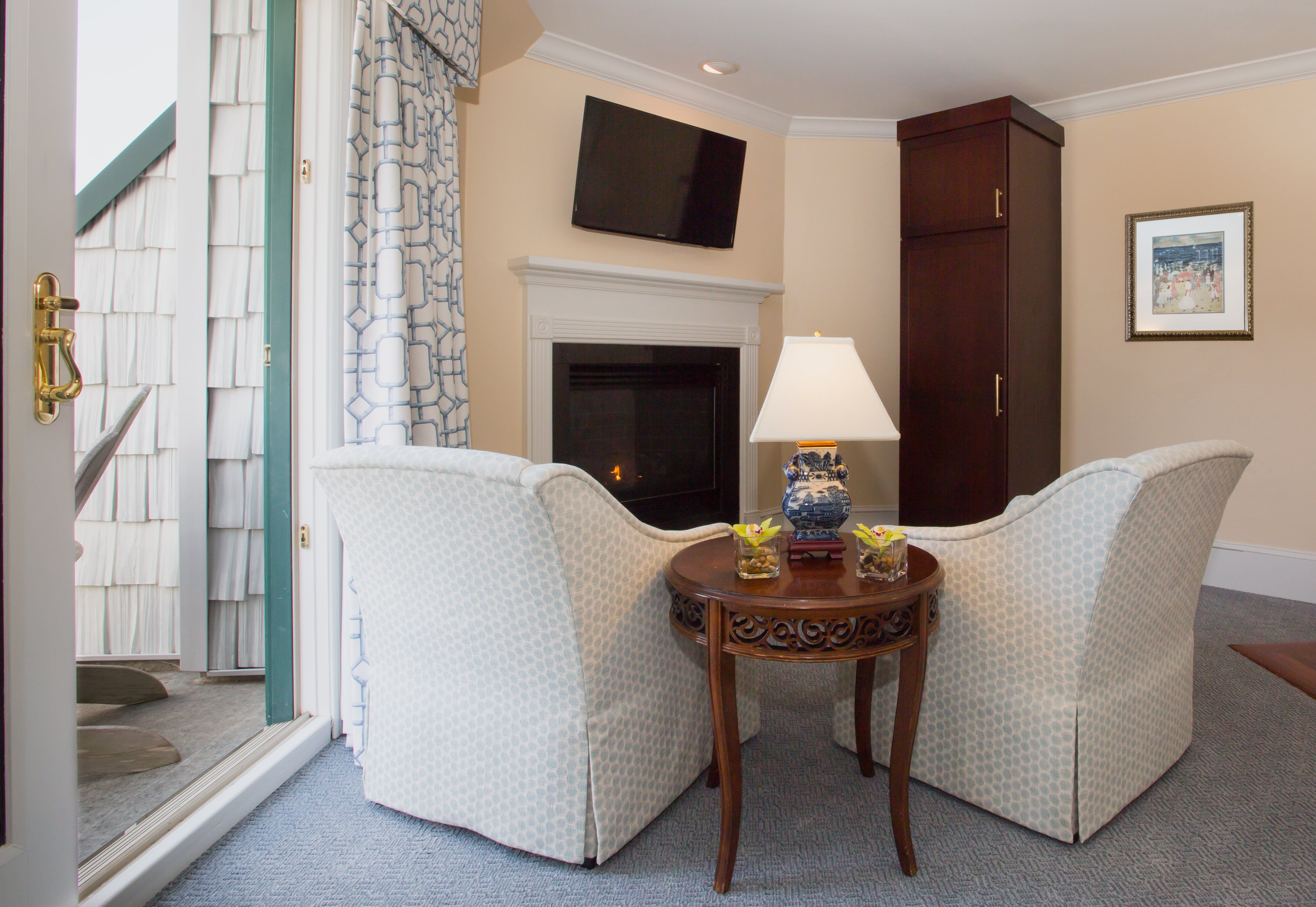 image A charming fireside nook with plush chairs offers the perfect spot to relax in comfort.