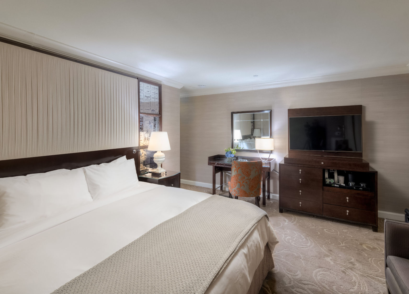 image Spacious and serene bedroom retreat, where plush bedding and warm lighting create the perfect escape.
