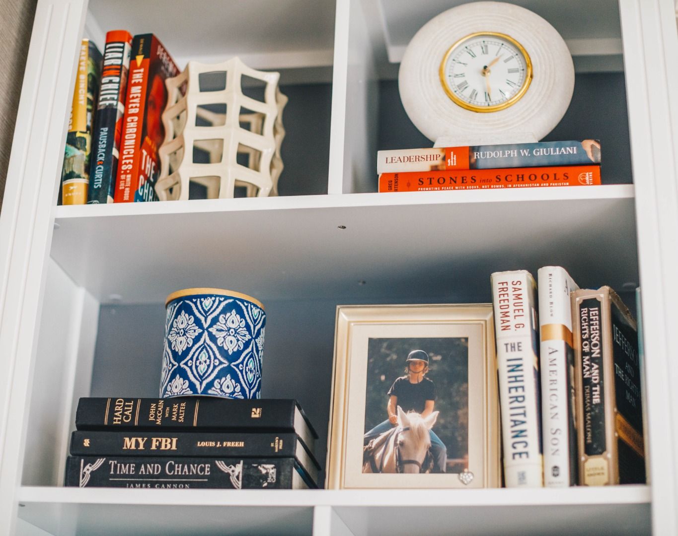 image A thoughtfully curated bookshelf, blending literature, art, and timeless decorative pieces.