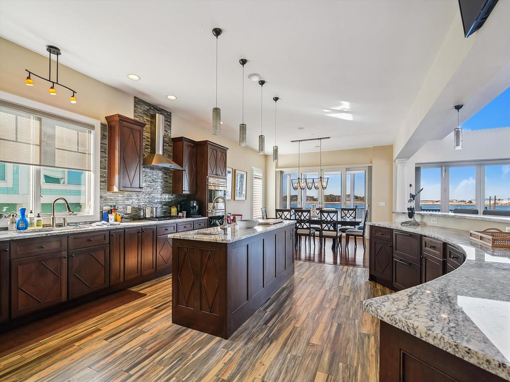 image This stunning modern kitchen features luxurious amenities, spacious countertops, and captivating bayfront views, making it a perfect space for culinary enthusiasts.