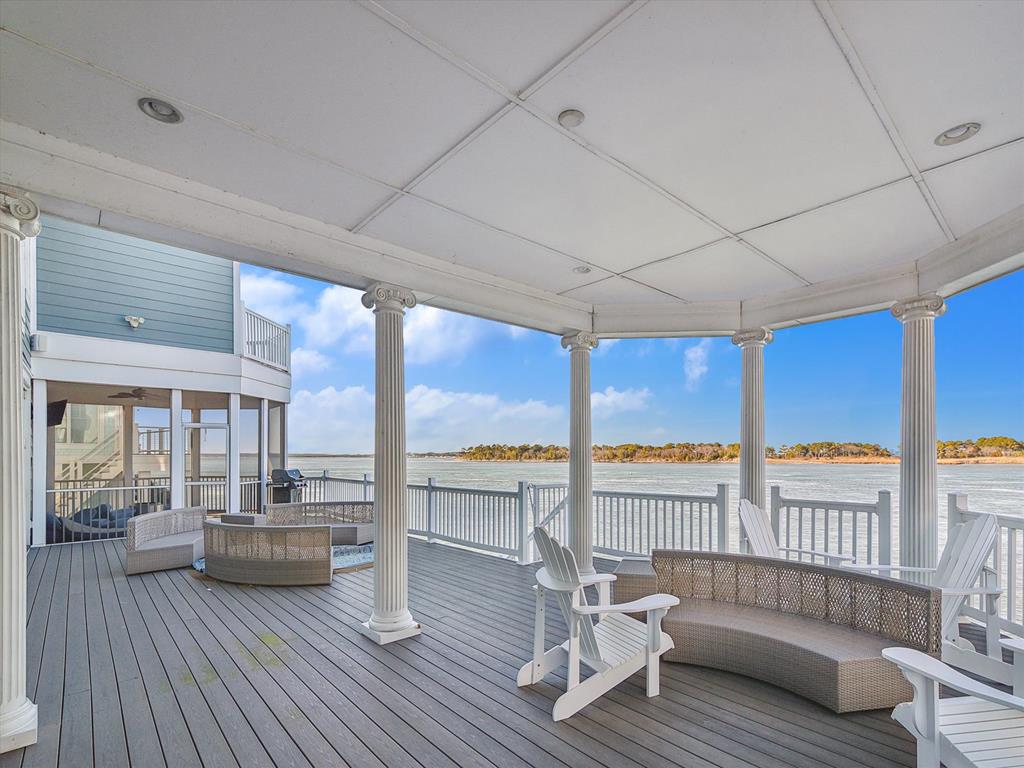 image Relax in the luxurious outdoor living area, equipped with comfortable seating and sweeping views of the bay.
