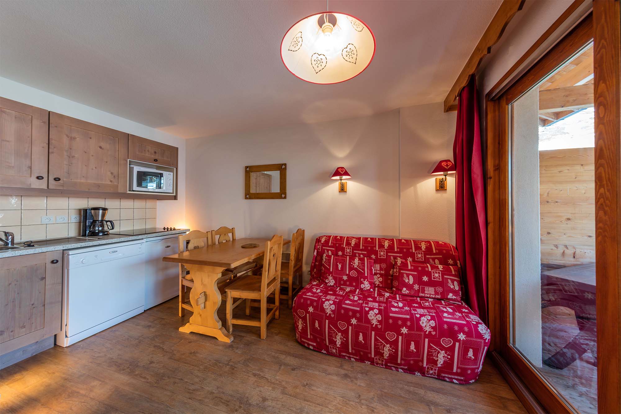 image A fully equipped kitchen and dining area, seamlessly blending functionality and comfort for a perfect stay.