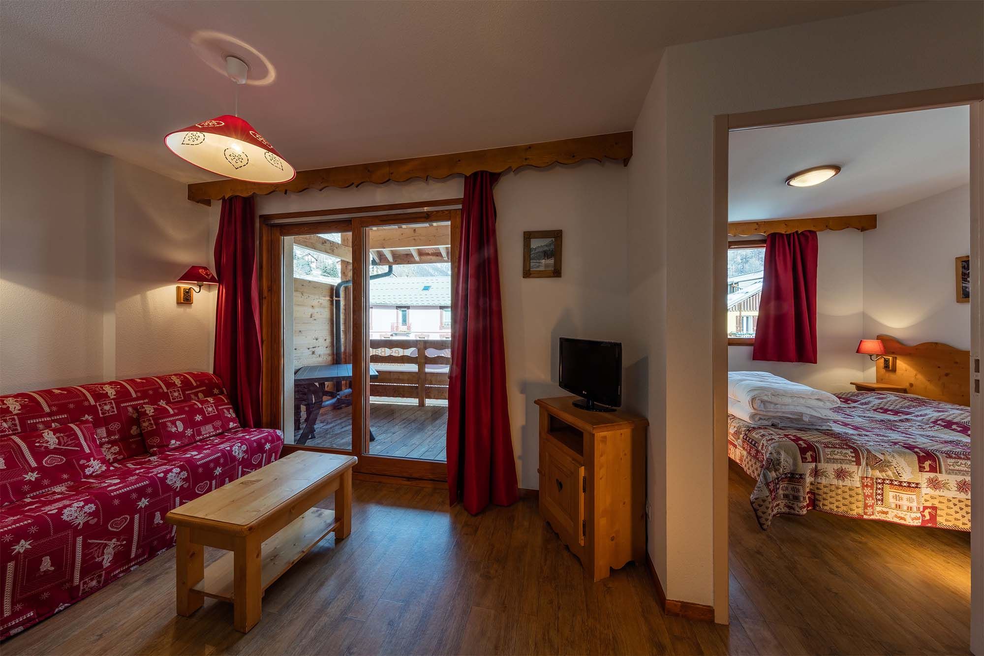 image A welcoming open-plan space connecting the living room and bedroom, creating a warm and inviting atmosphere.