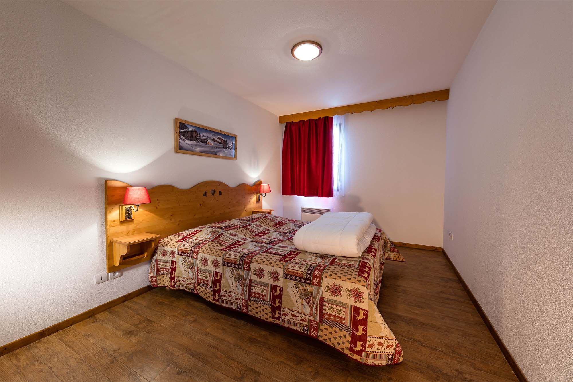 image A charming bedroom with warm wooden accents and soft lighting for a restful night in the mountains.