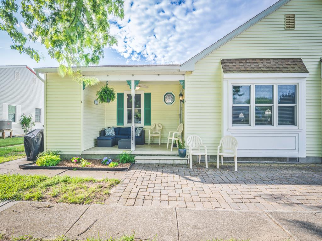 image A bright and inviting exterior with a spacious outdoor seating area.