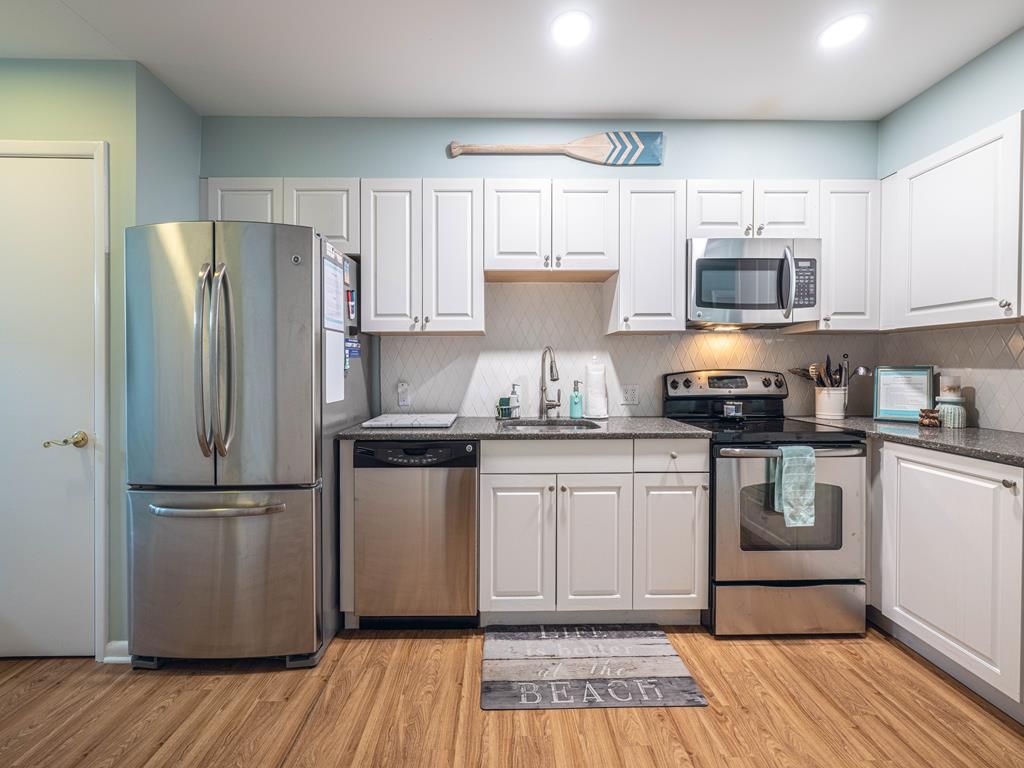 image Fully equipped kitchen with stainless steel appliances, ample cabinetry, and modern finishes.