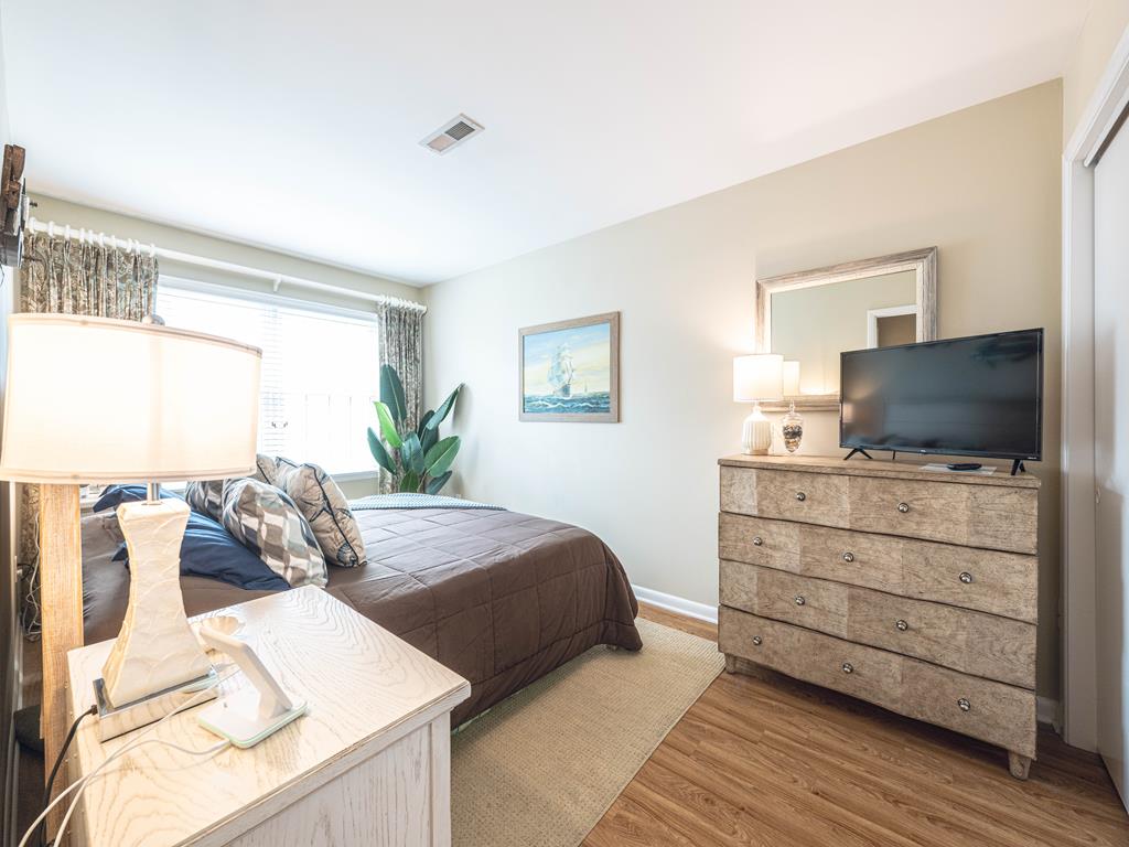 image Comfortable bedroom with elegant furnishings, a TV, and warm lighting for a restful retreat.