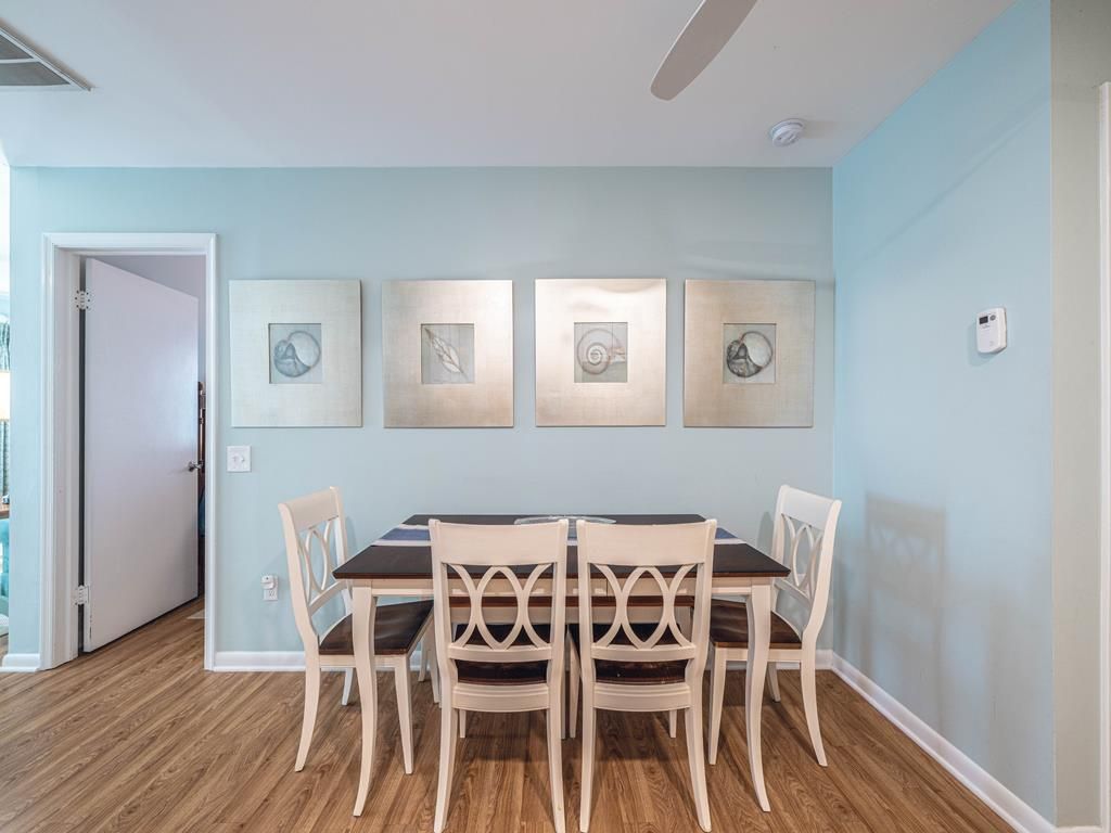 image Coastal-inspired dining area with seating for six, elegant wall art, and a relaxing beach-themed ambiance.