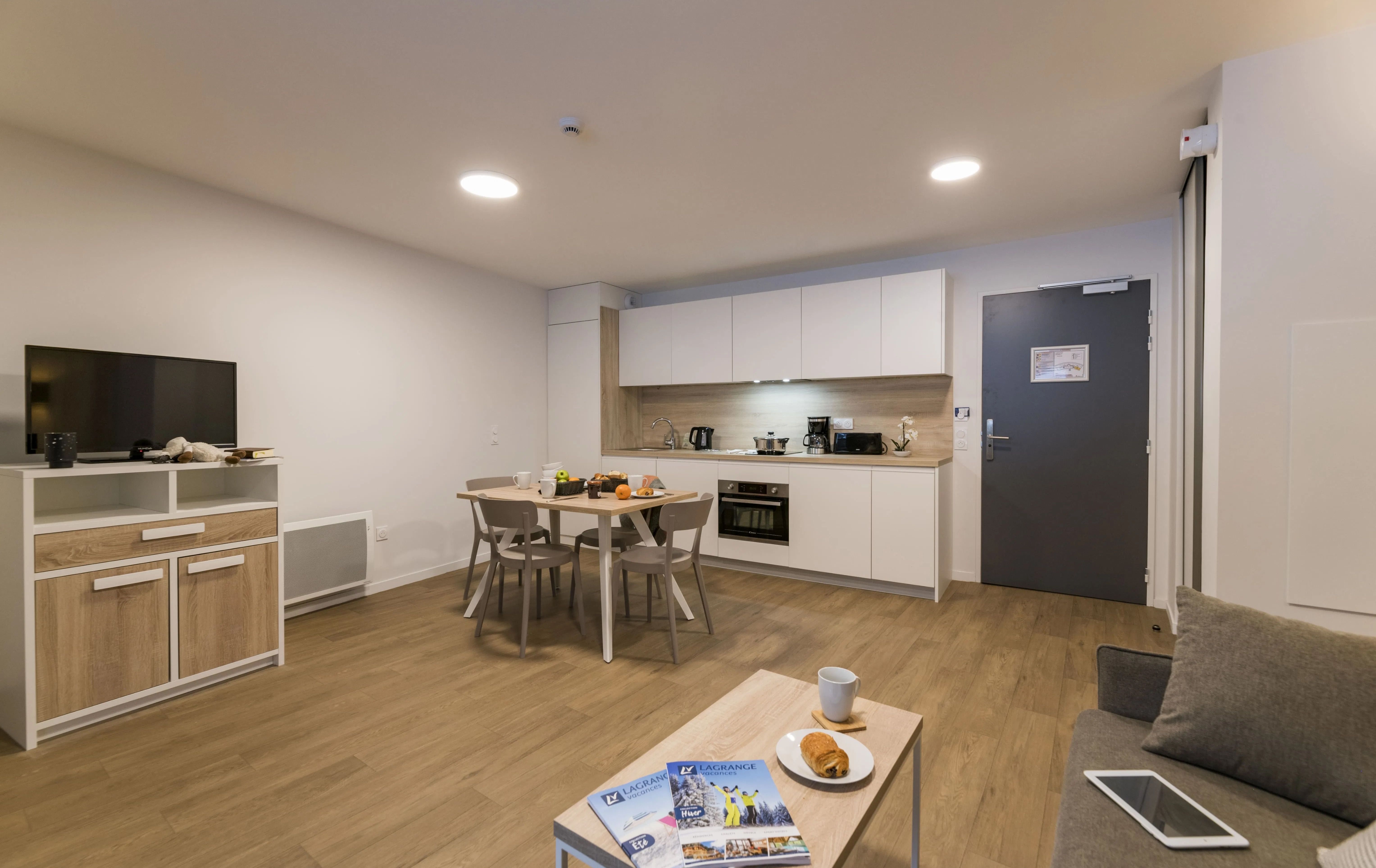 image This cozy studio features a bright and modern kitchen area, perfect for preparing meals after a day on the slopes. Enjoy breakfast for two at the inviting dining table.