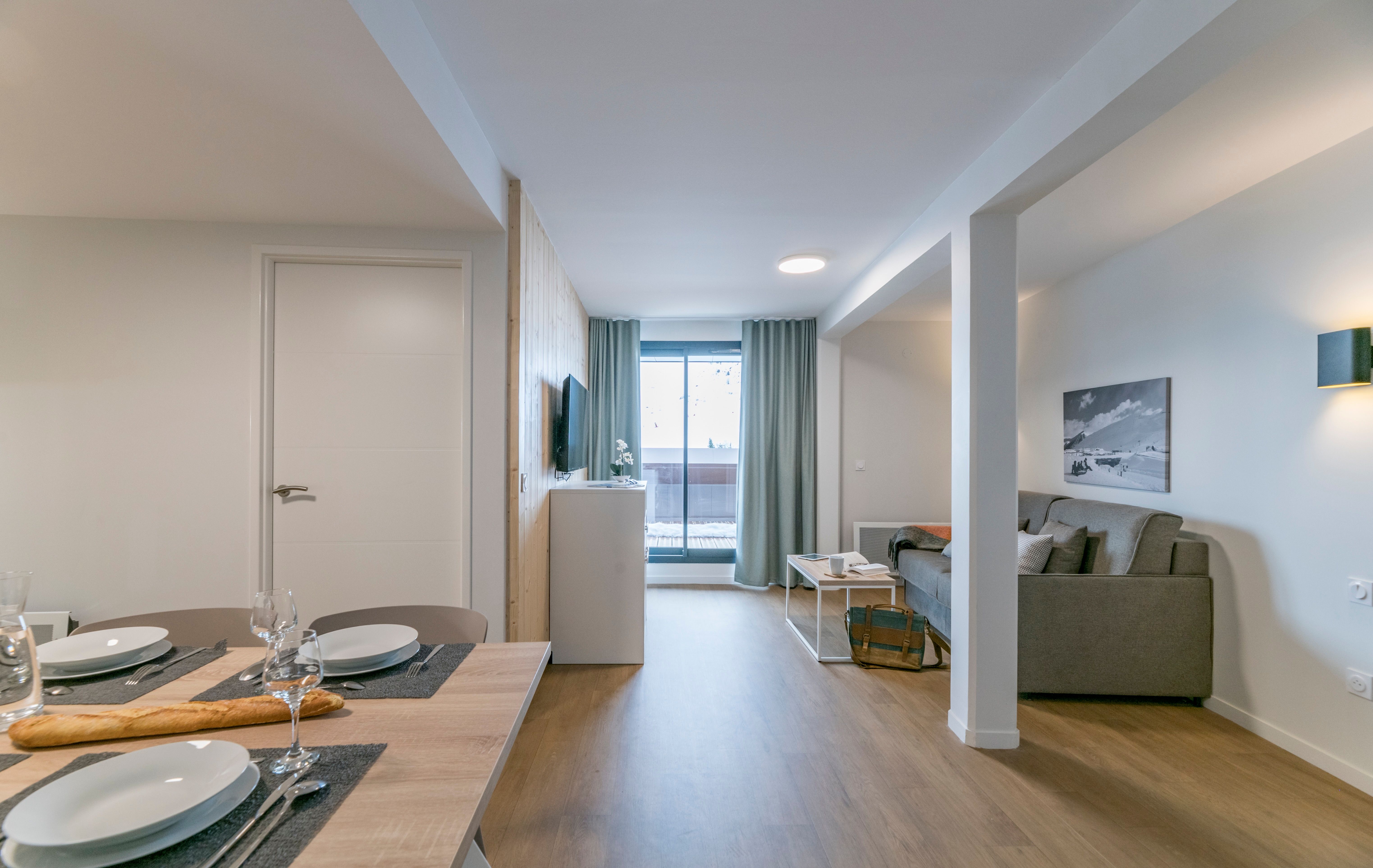 image Relax in the spacious living area, designed with comfort in mind, where large windows allow natural light to flood in and showcase the stunning mountain backdrop just outside.