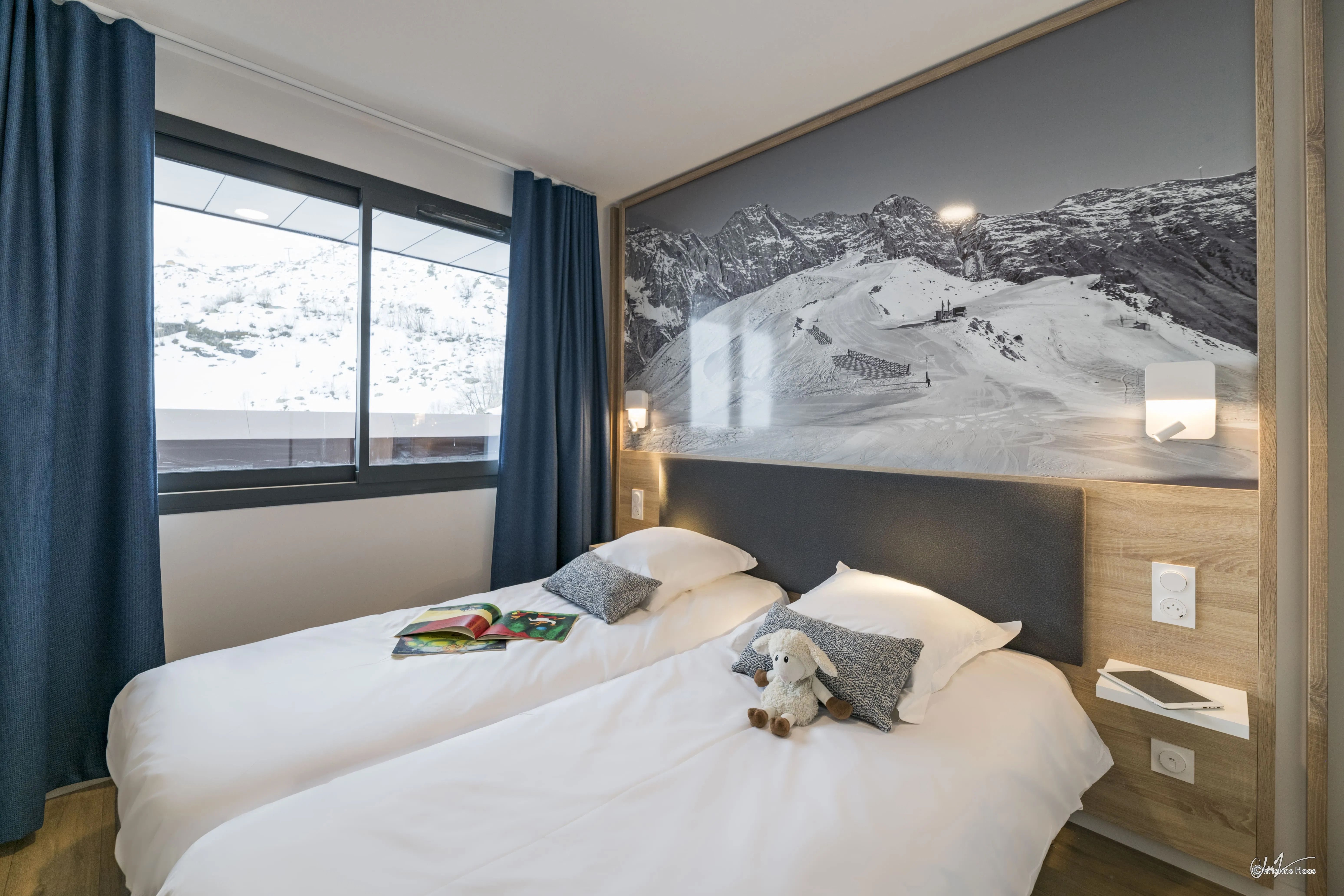 image The tranquil bedroom features twin beds adorned with plush pillows, perfect for restful nights after exciting days of mountain adventures.