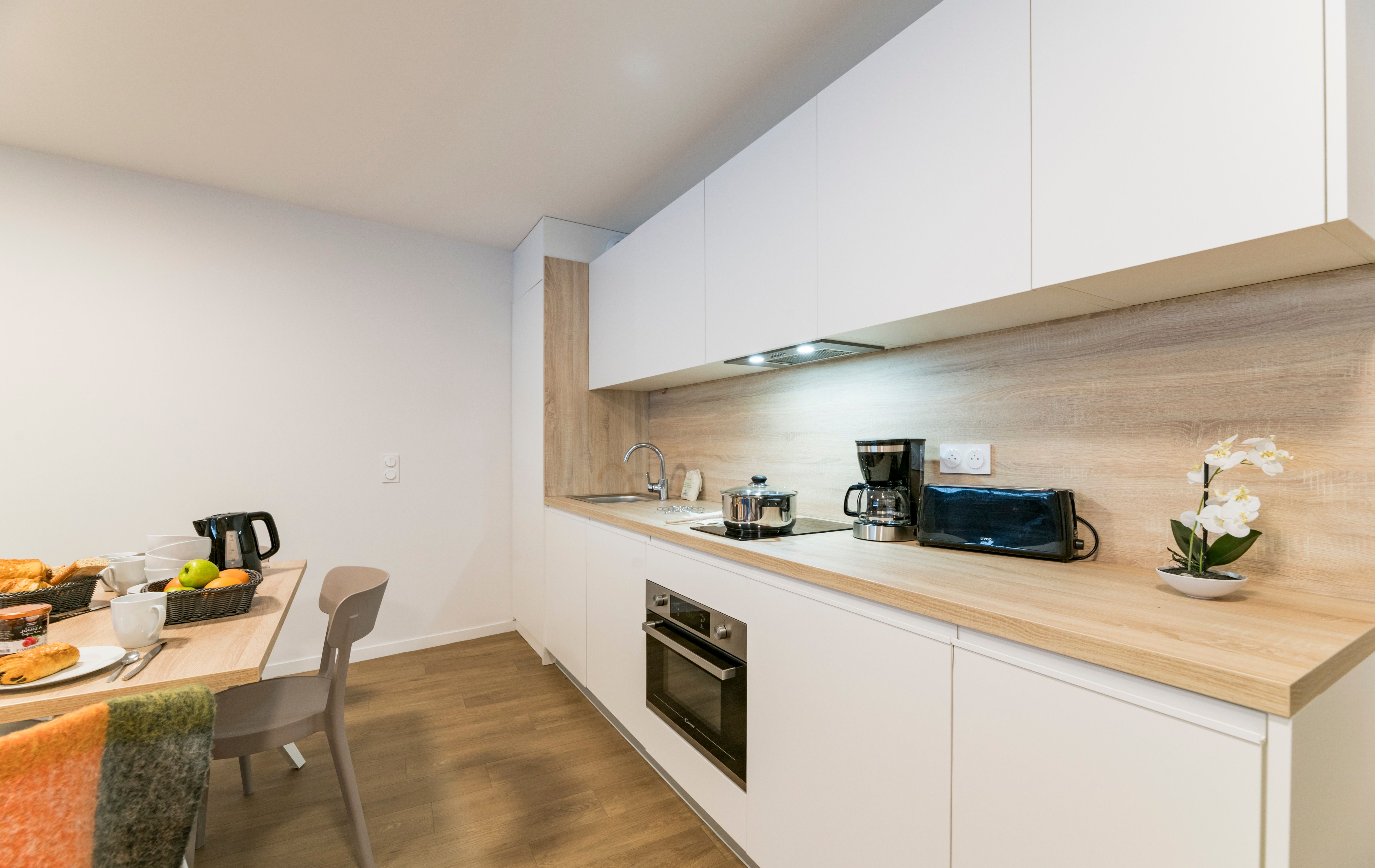 image Cook together in the stylish kitchen, equipped with modern appliances and ample space for family meals, creating memories over delicious home-cooked dishes.