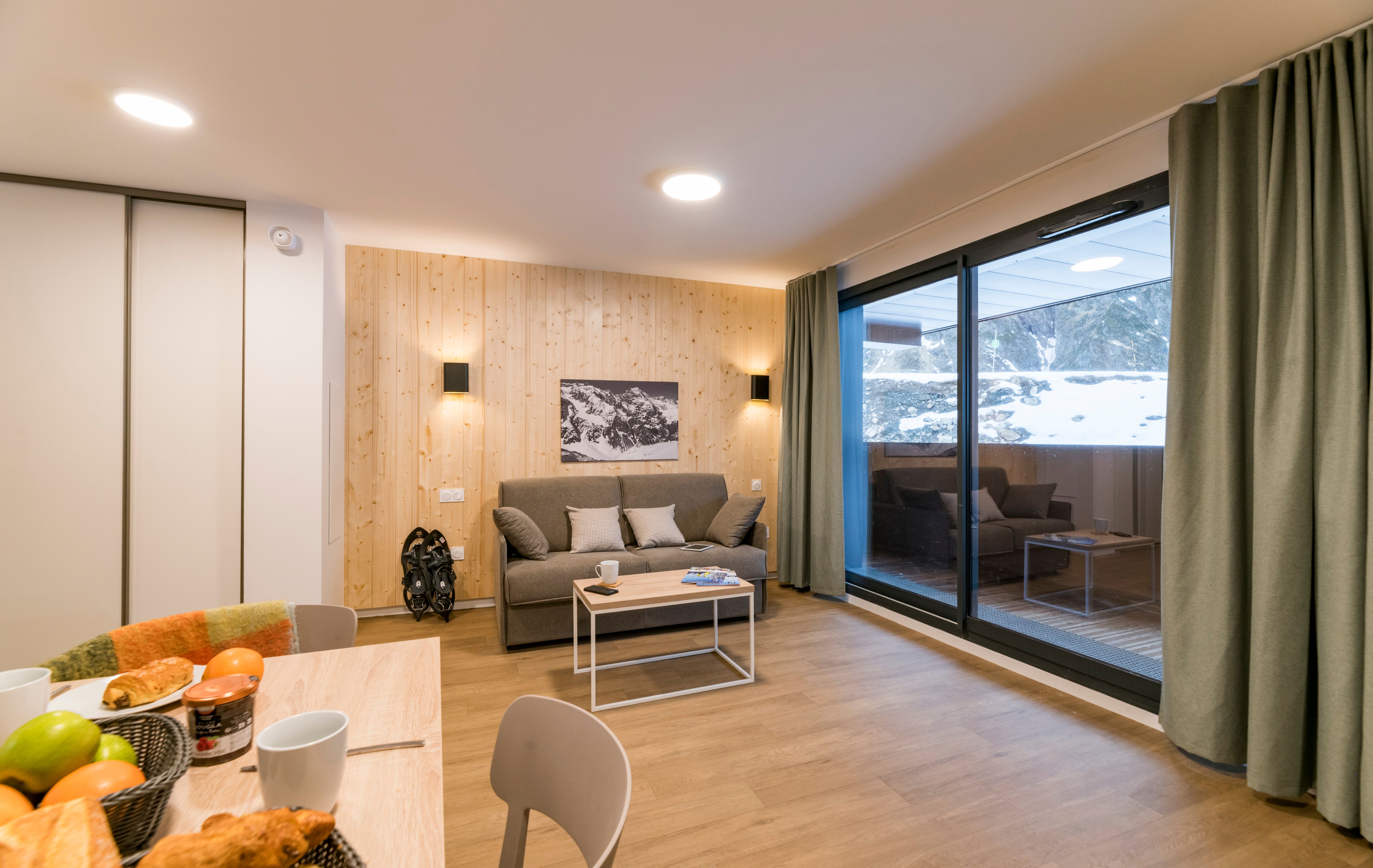 image Step into a warm, inviting space with a comfortable sofa and tasteful decor, creating the perfect setting for relaxation and entertainment.