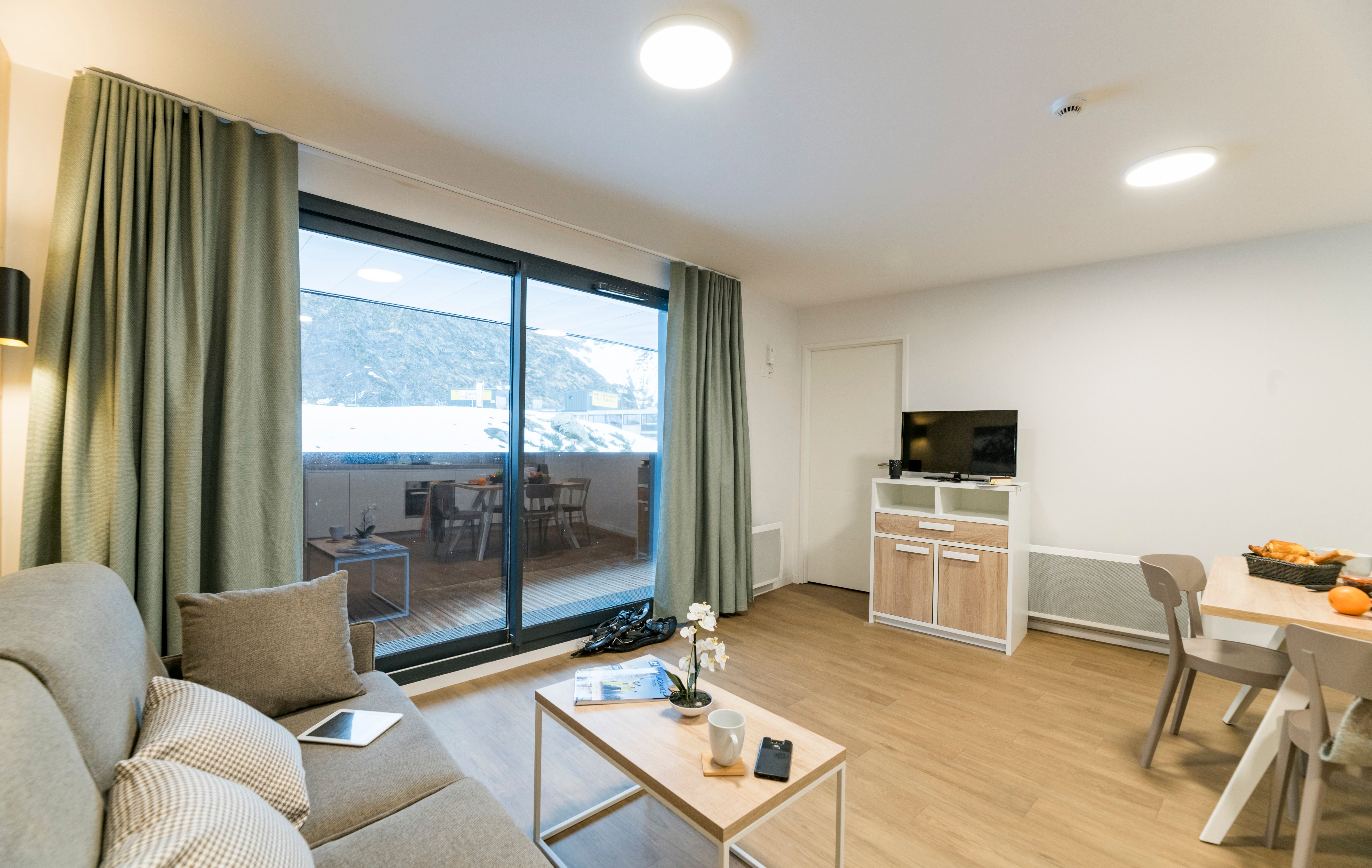 image The airy living area offers a seamless indoor-outdoor experience, where you can enjoy stunning views from the comfort of your stylish retreat.