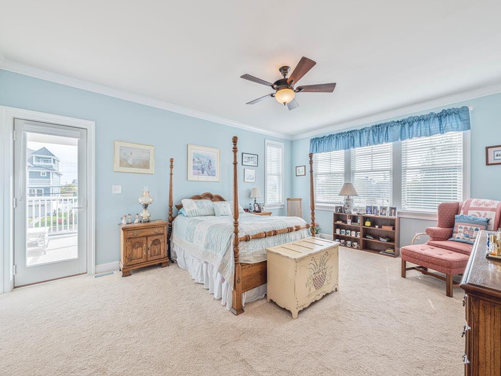 image Spacious and bright bedroom with large windows, elegant decor, and plenty of natural light.