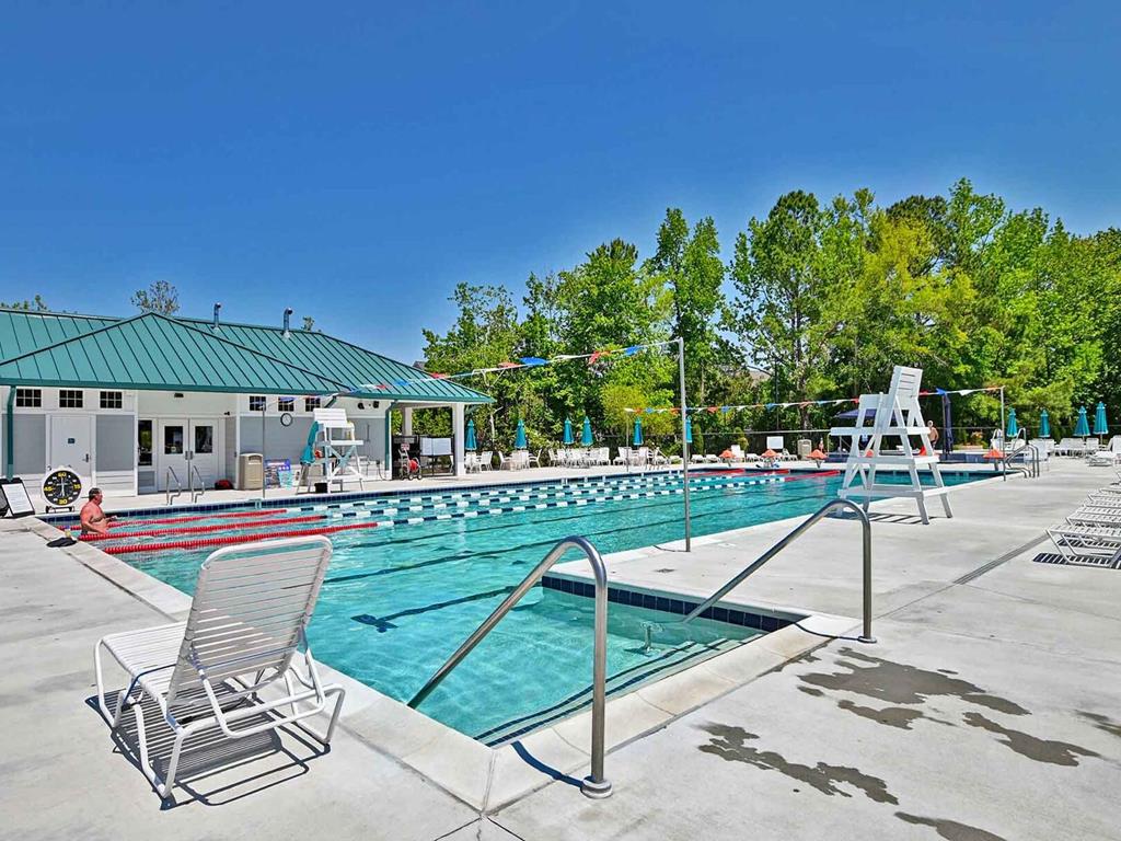 image Take a refreshing dip in the community's large outdoor pool, ideal for both relaxation and swimming laps.
