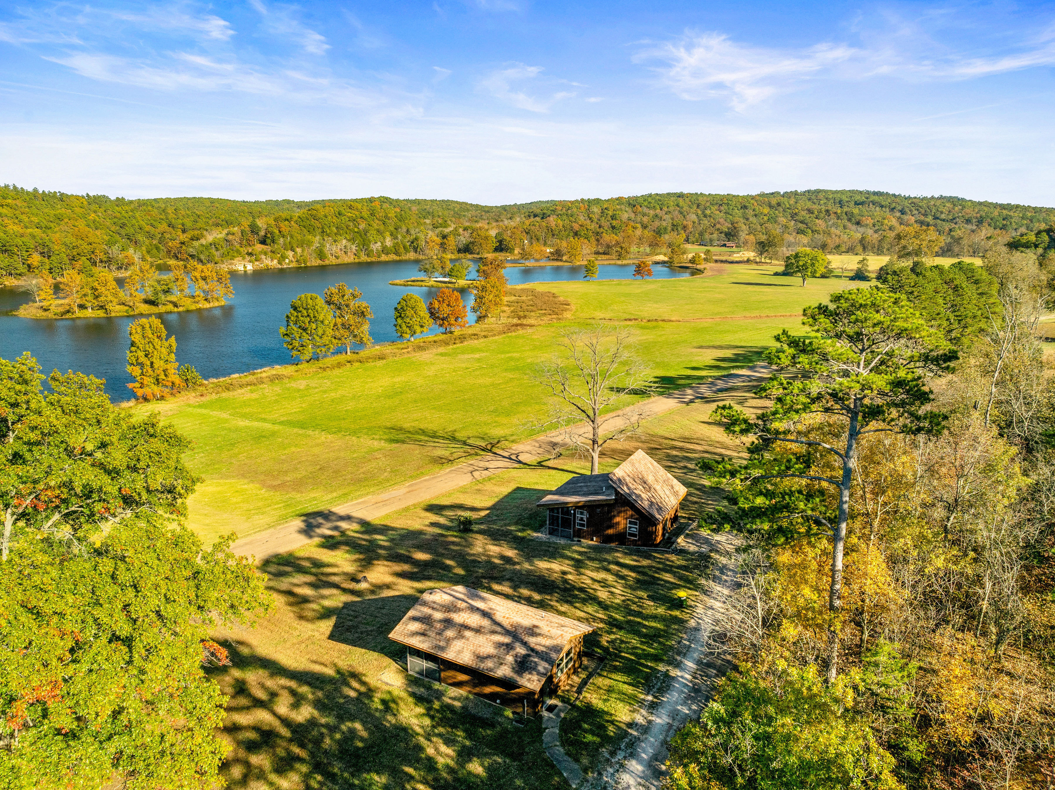 image Stunning aerial view of Bluff View Cabin, showcasing its serene lakefront setting and access to outdoor adventures.