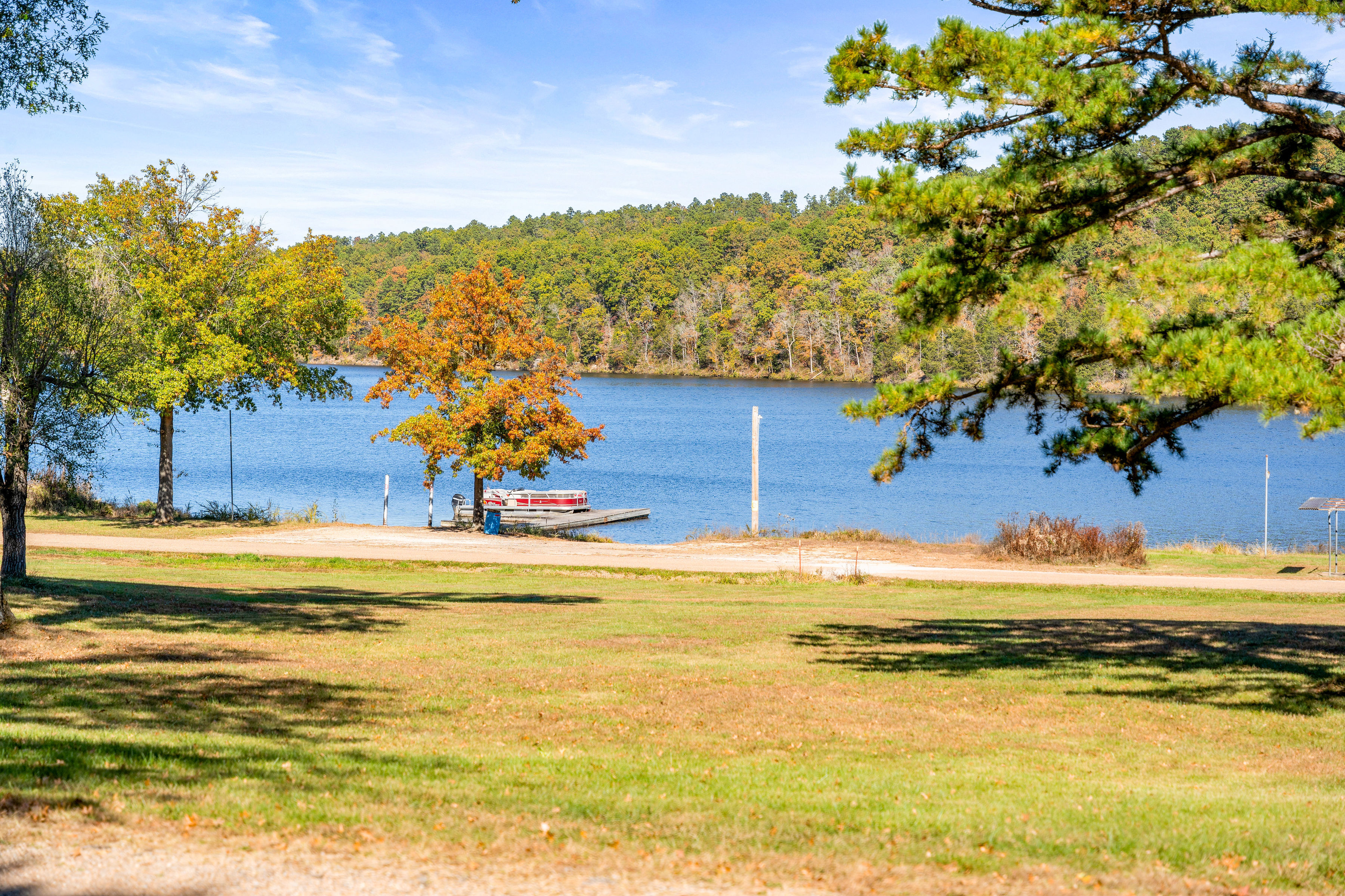 image Stunning lakefront views with crystal-clear water and vibrant fall foliage—an ideal backdrop for relaxation.