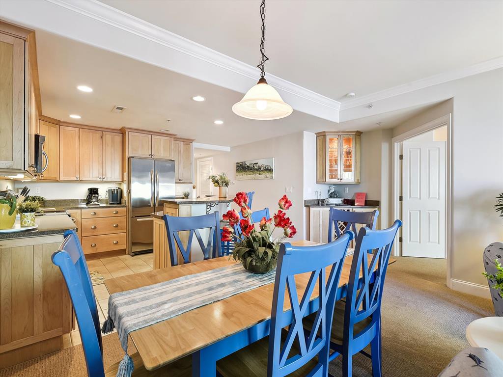 image Enjoy modern amenities in the open-concept kitchen and dining area, showcasing stylish cabinetry and a welcoming atmosphere ideal for family gatherings.