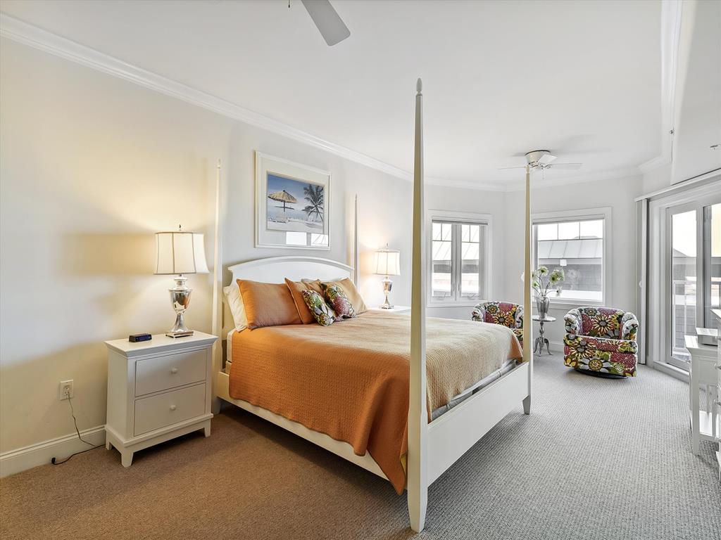 image Luxurious comfort continues in the master bedrooms, each adorned with cozy accents and windows that invite natural light, perfect for unwinding after a day at the beach.