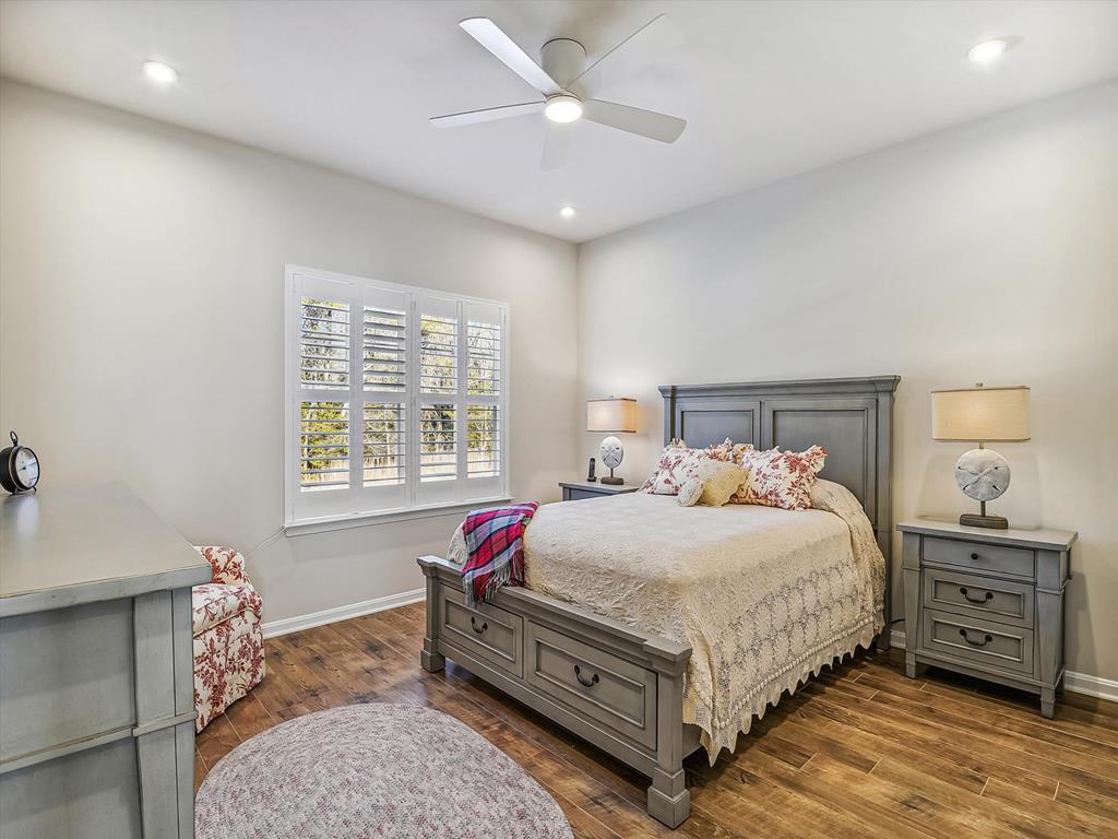 image A beautifully furnished guest room showcases comfort and charm, making it an ideal sanctuary for relaxation after enjoying the extensive leisure lifestyle and resort access that this home offers.