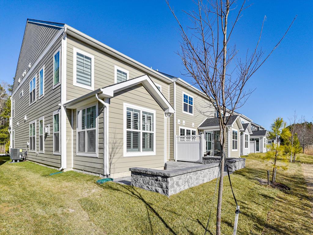 image This luxurious 4-bedroom twin home features a modern exterior, blending seamlessly with the serene surroundings near Fenwick Island, Delaware.