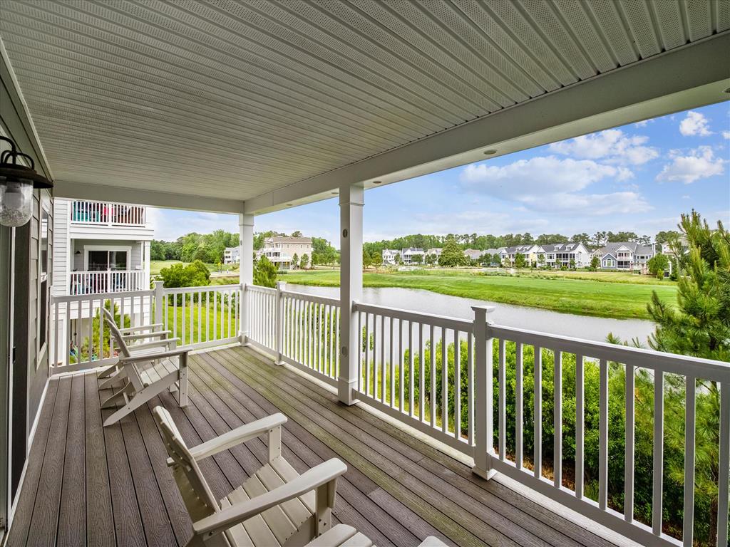 image Spacious covered balcony with rocking chairs, offering breathtaking views of the golf course—perfect for morning coffee or evening relaxation.