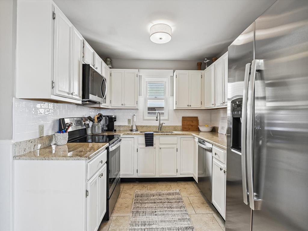 image Fully equipped modern kitchen with stainless steel appliances.