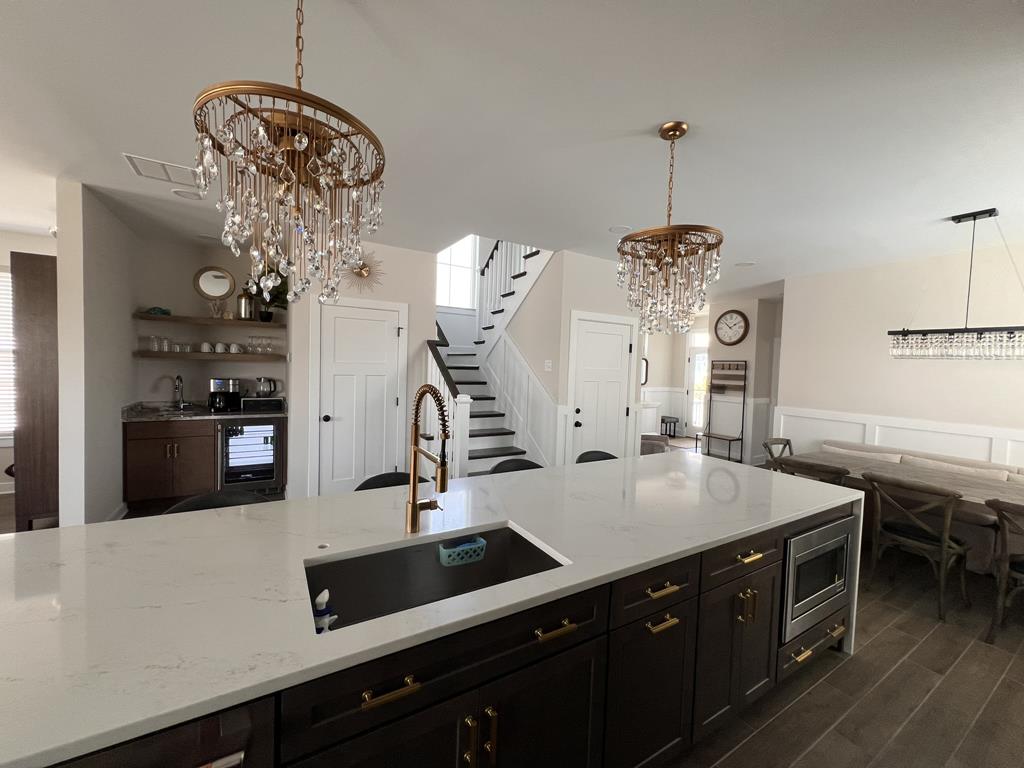 image Another angle of the gourmet kitchen, highlighting sleek countertops and stylish lighting fixtures.
