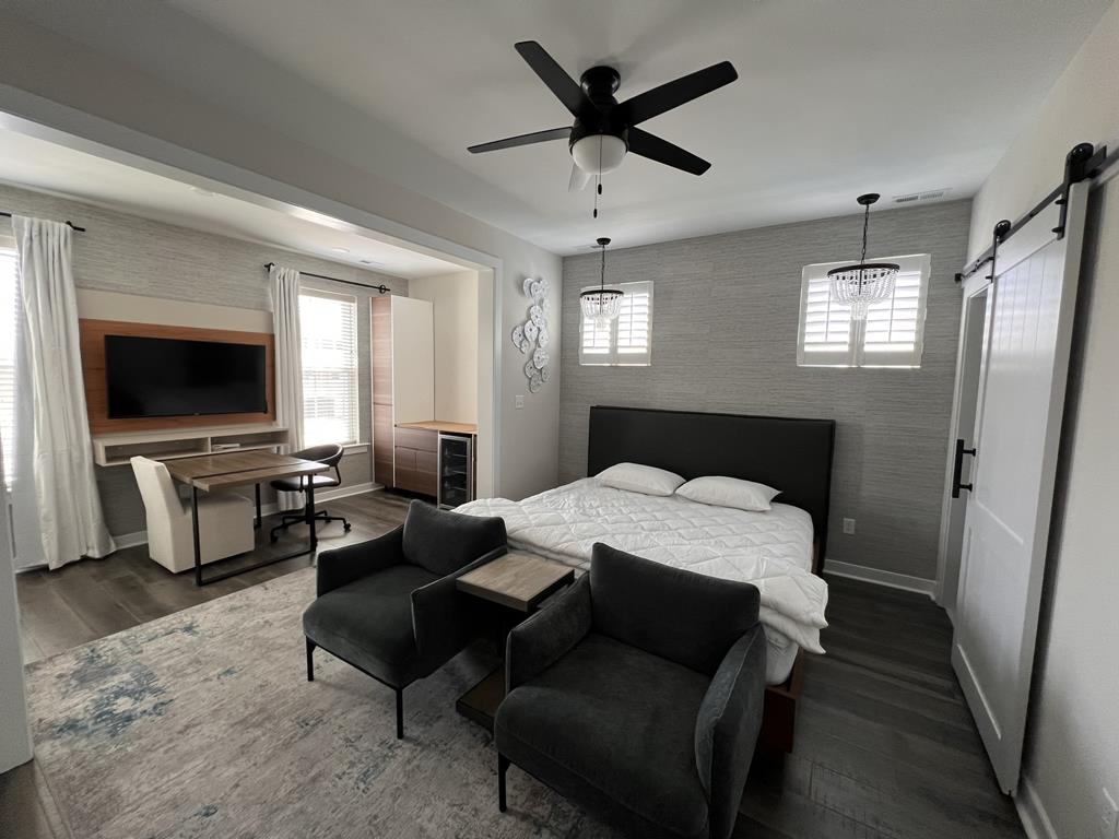 image Stylish and cozy living space with plush seating and a mounted TV, perfect for unwinding after a beach day.