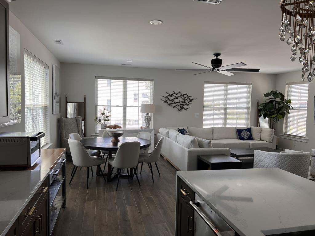 image Open-concept living and dining area with plenty of natural light, perfect for relaxing or entertaining.