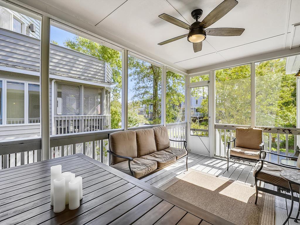 image Bathed in natural light, the screened porch offers a cozy retreat with plush seating, ideal for savoring the coastal breeze while staying sheltered from insects.