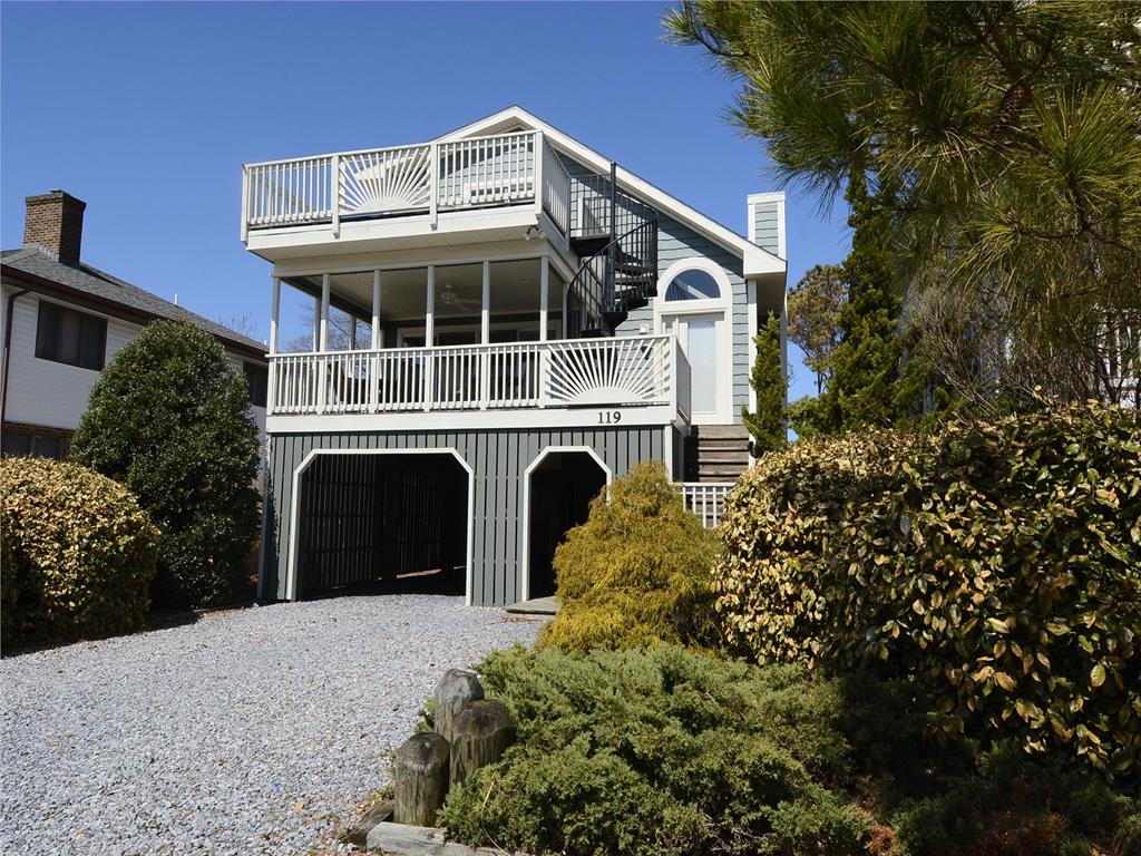 image Stunning beach house with a spacious wraparound deck, perfect for enjoying ocean breezes.